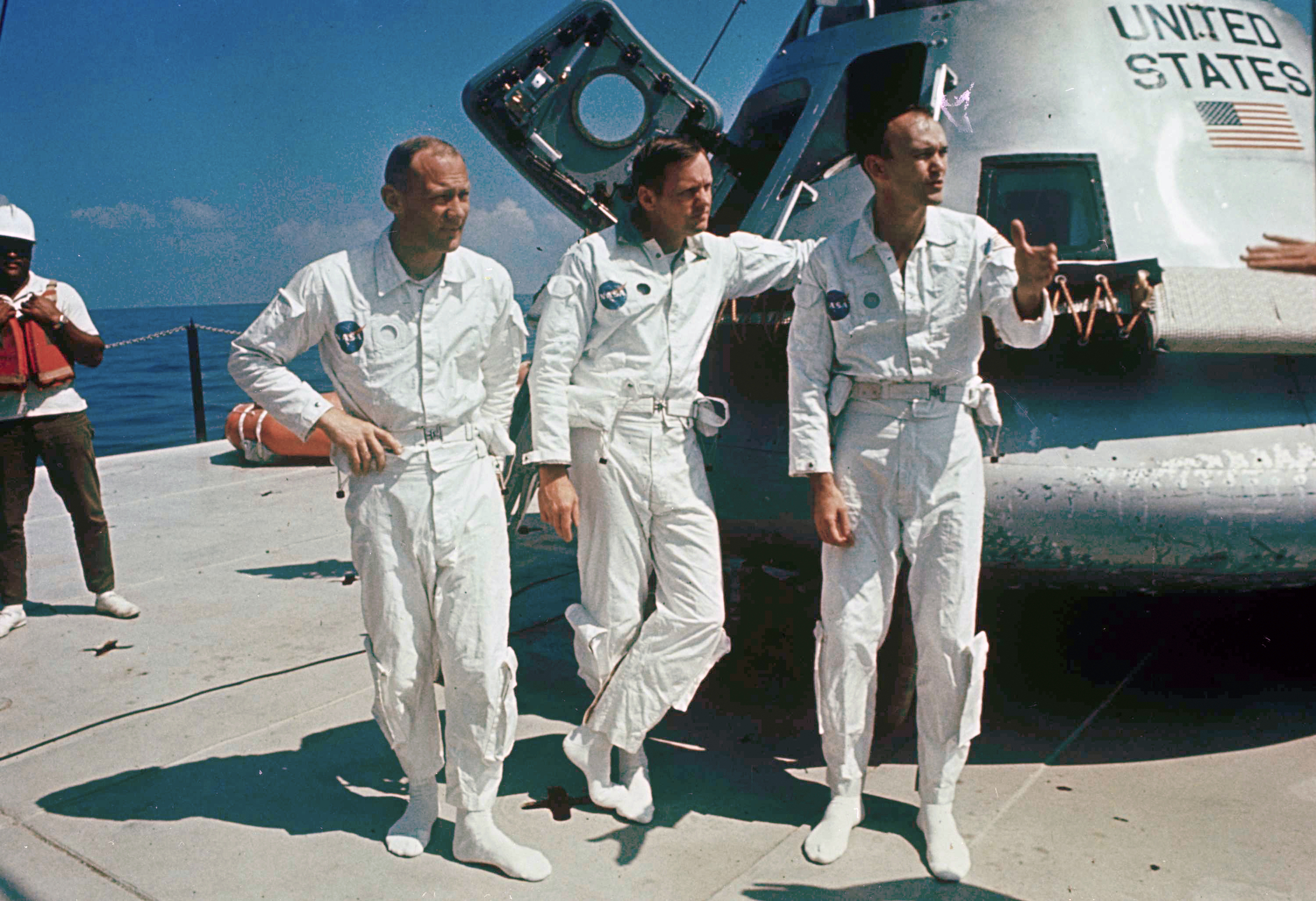 Apollo 11 astronauts, from left, Edwin "Buzz" Aldrin, lunar module pilot; Neil Armstrong, flight commander; and Michael Collins, command module pilot, next to their spacecraft.