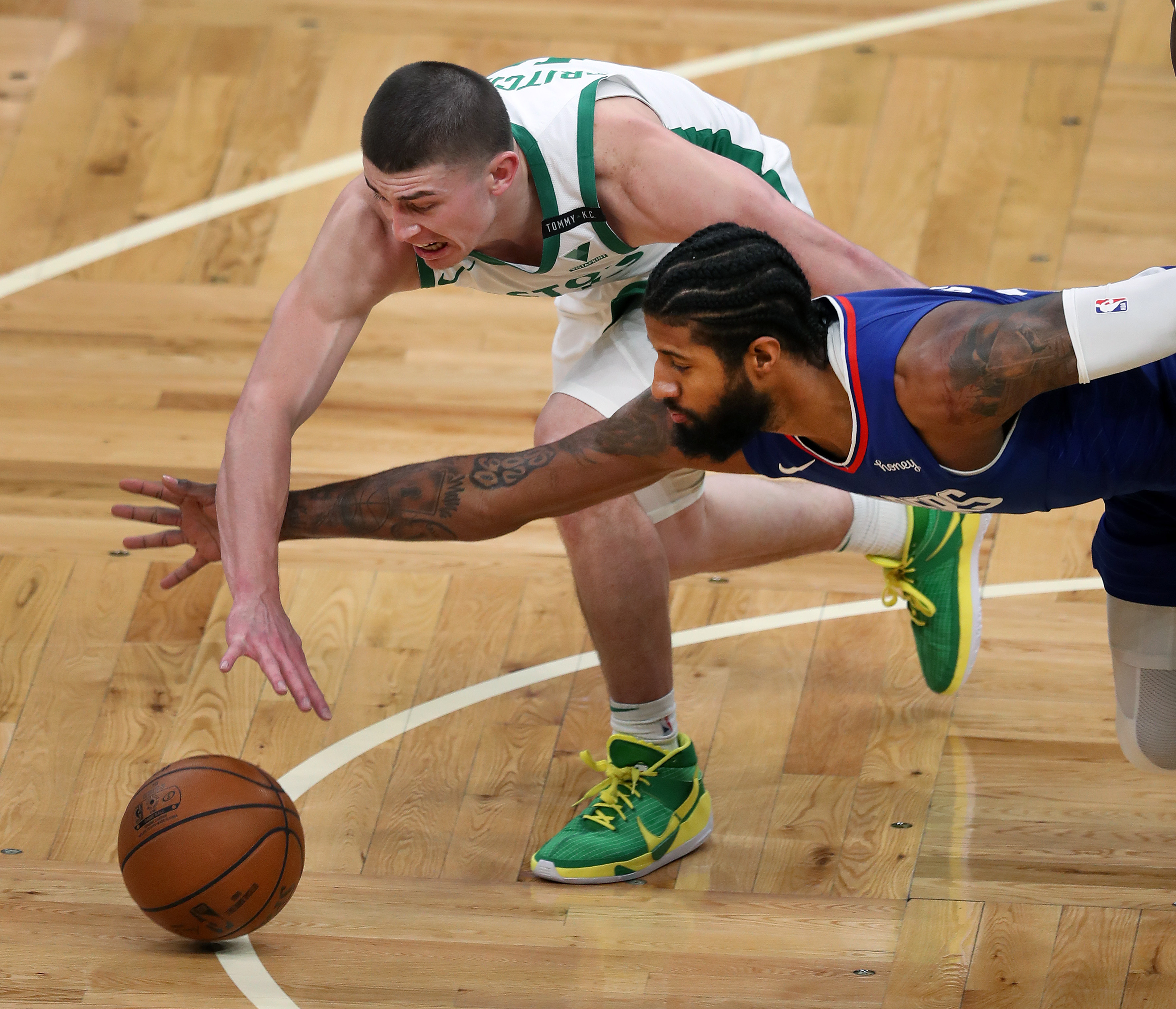 Payton Pritchard and Paul George hit the floor together as they vie for a second-quarter loose ball.