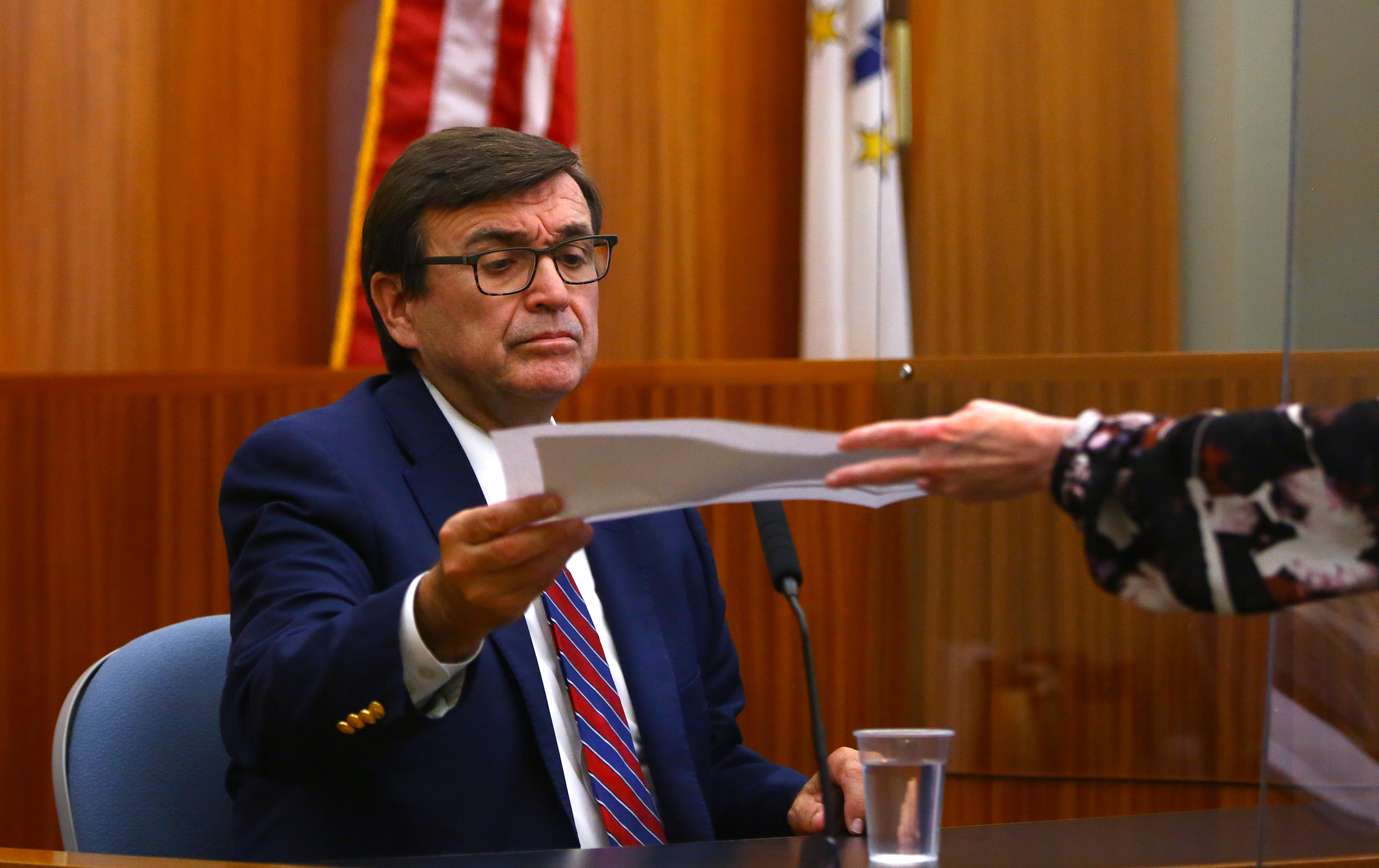 Leo Skenyon, chief of staff for House Speaker Nicholas A. Mattiello, was handed a document by clerk Judy Bonin from defense attorney Robert Clark Corrente.