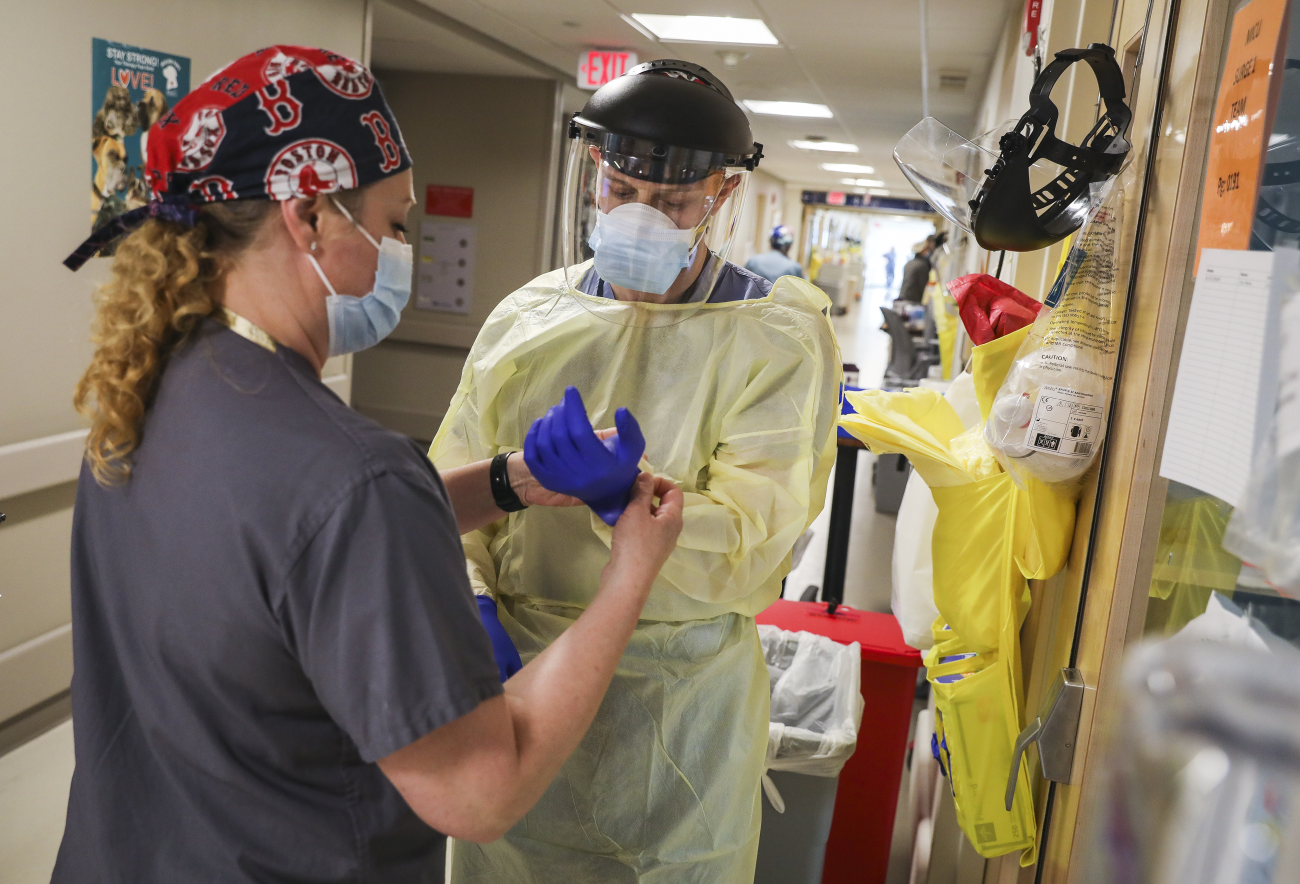BMC permanent charge nurse Jill Robertson checked the personal protective equipment of pulmonary fellow Samuel Belok before he entered the room of a COVID-19 patient on the ICU floor.