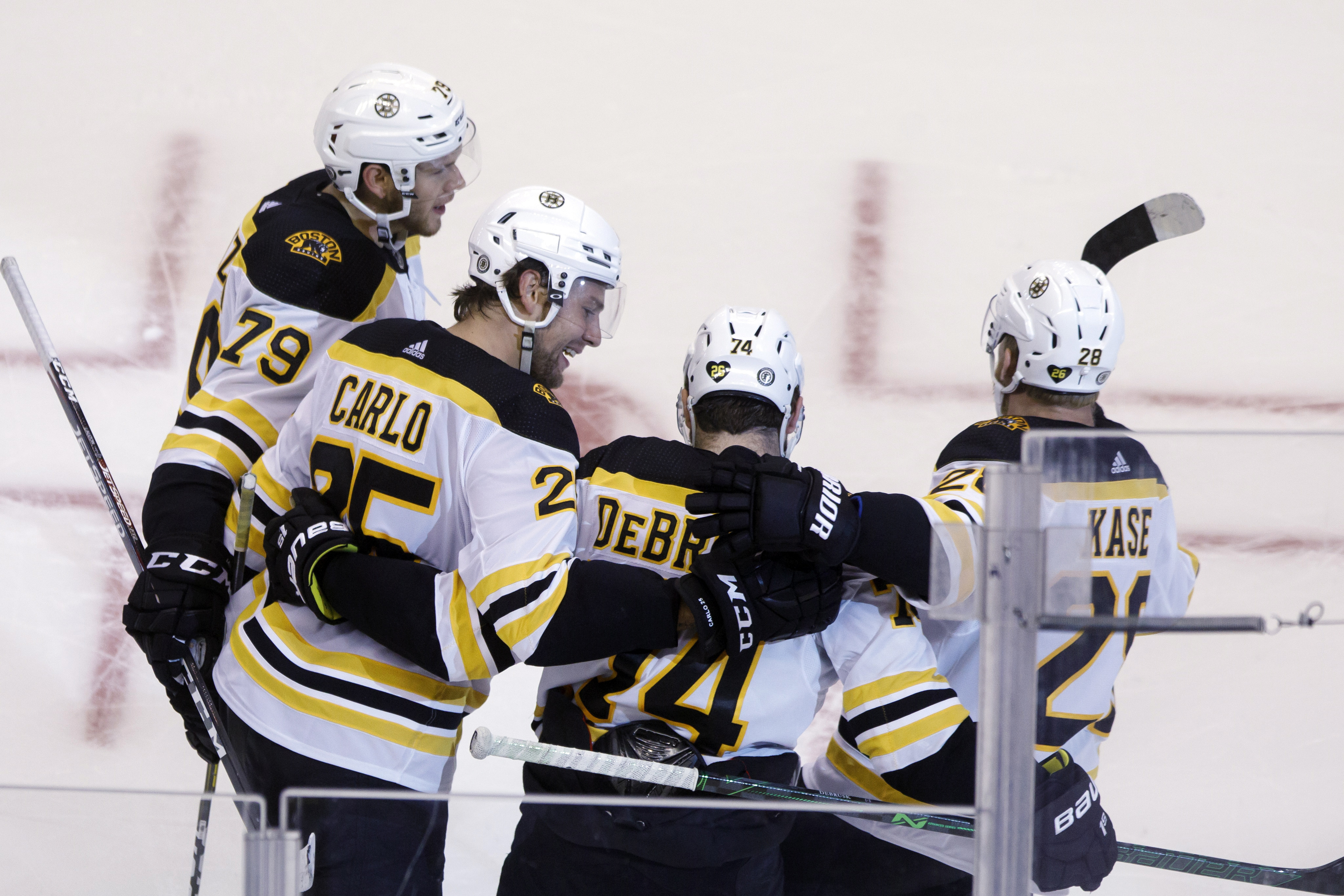 Brandon Carlo (25) looks to left wing Jake DeBrusk (74) as they celebrate DeBrusk's goal against the Washington Capitals on Sunday.