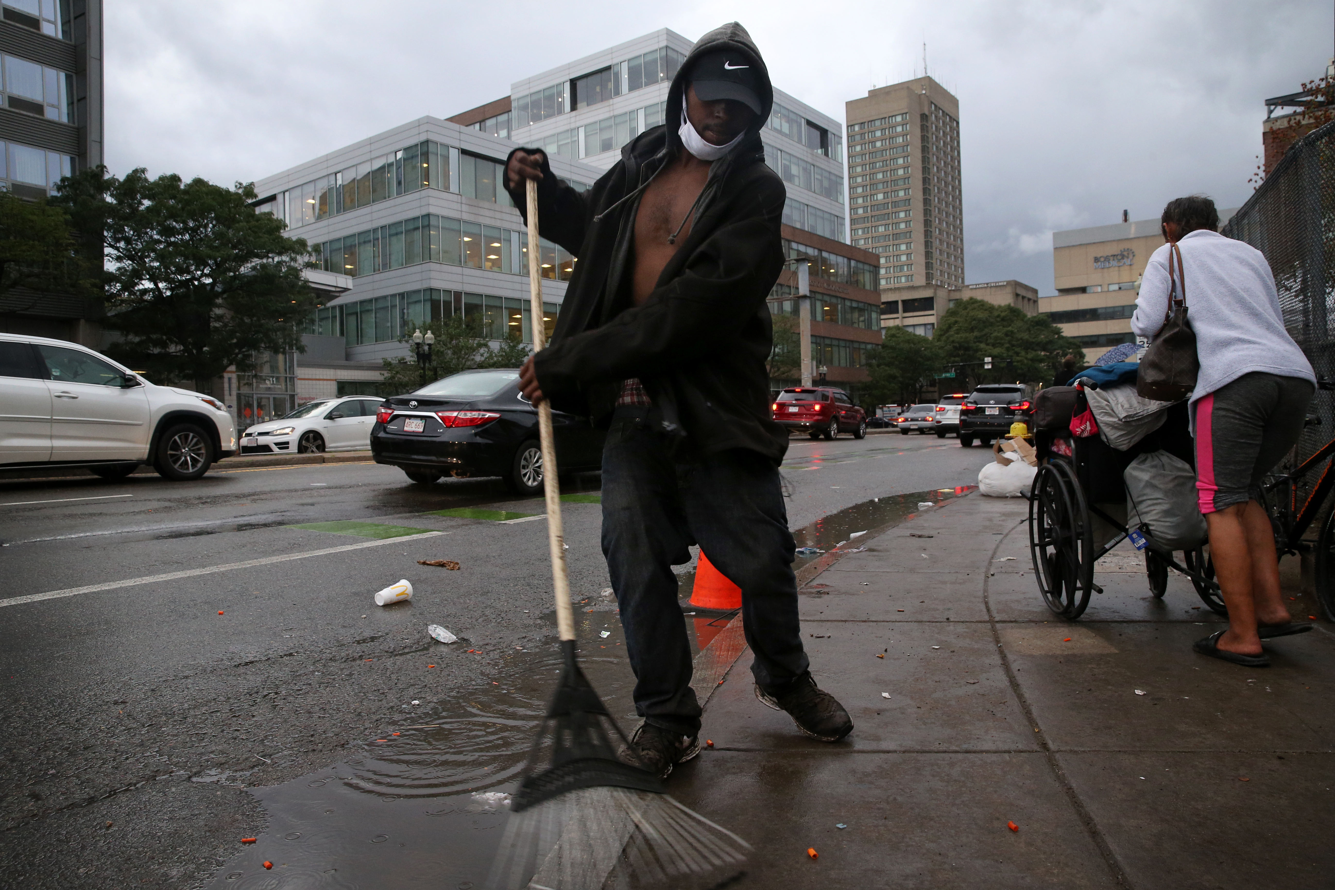 Malik Calderon Jr. cleaned the sidewalk outside a comfort station as it closed for the day. Calderon is homeless and appreciates the station. "This place saves lives, they have good resources and a good staff. They got me in the methadone clinic. We get support here. This is a community," he said.