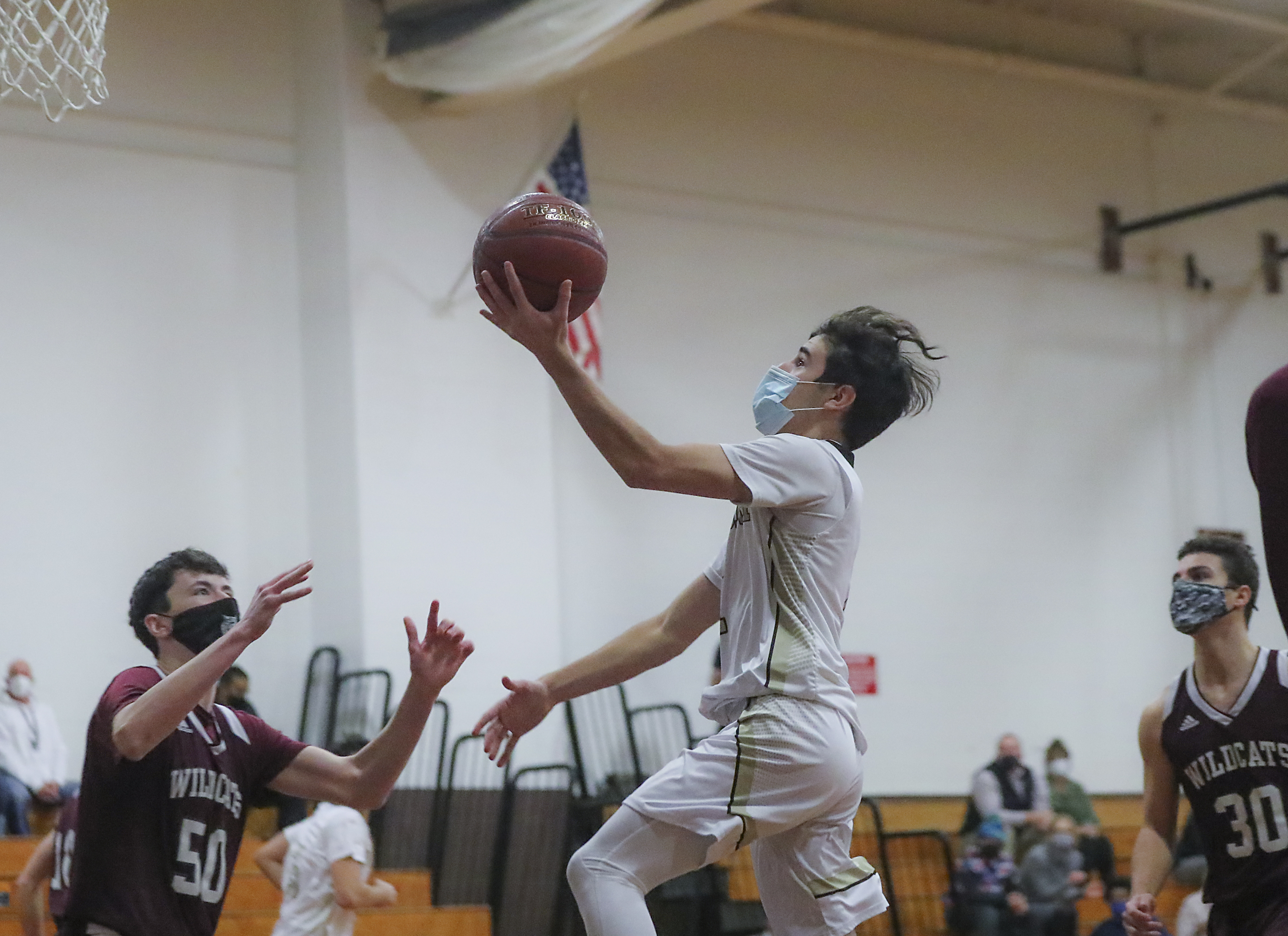 Westport's Hunter Brodeur soars to the basket as West Bridgewater's Ryan McGrath (50) defends in Tuesday's MAC final in Westport.