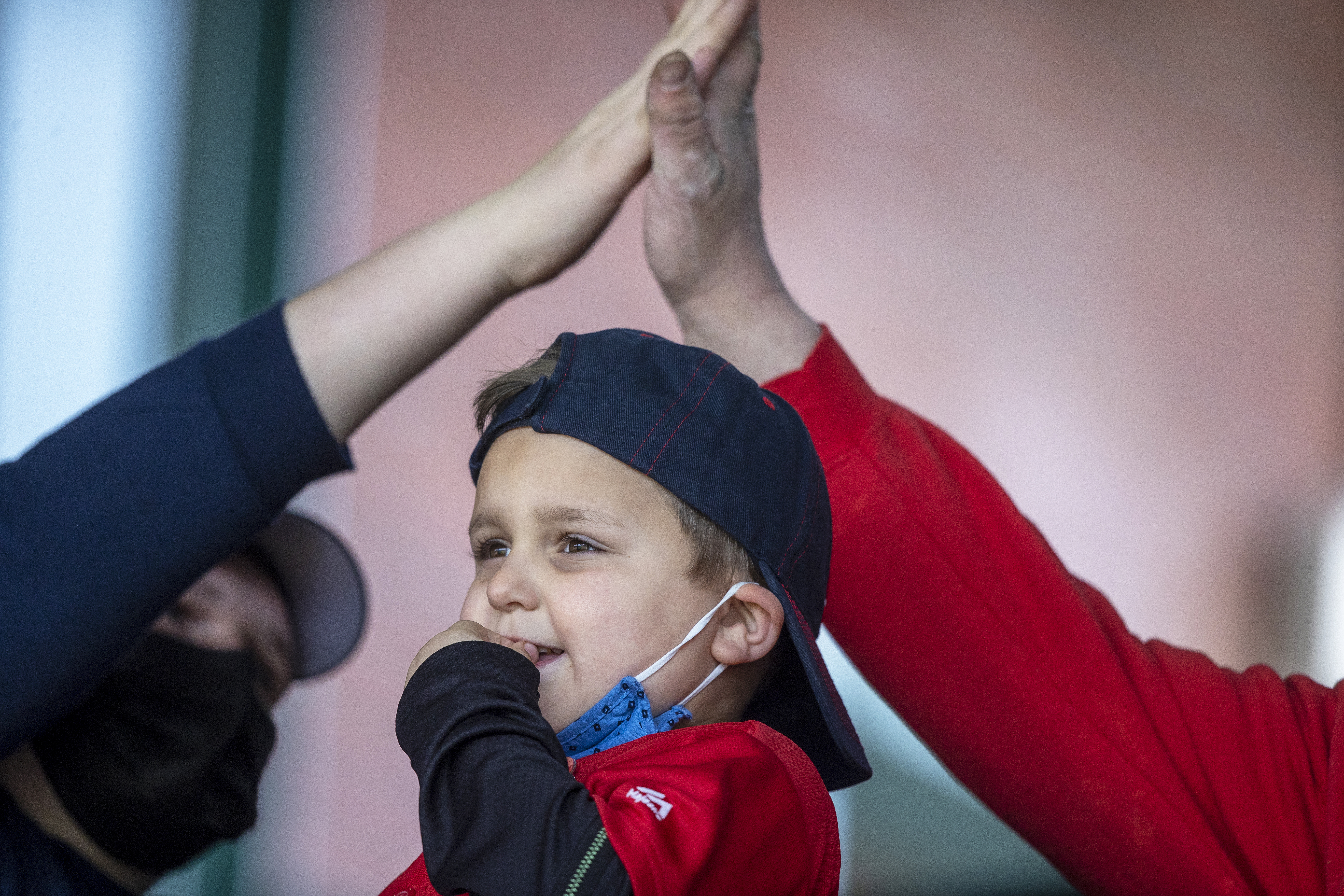 Ryan Schumann, 5, of Kingston, watched the Red Sox score as his parents high-fived.
