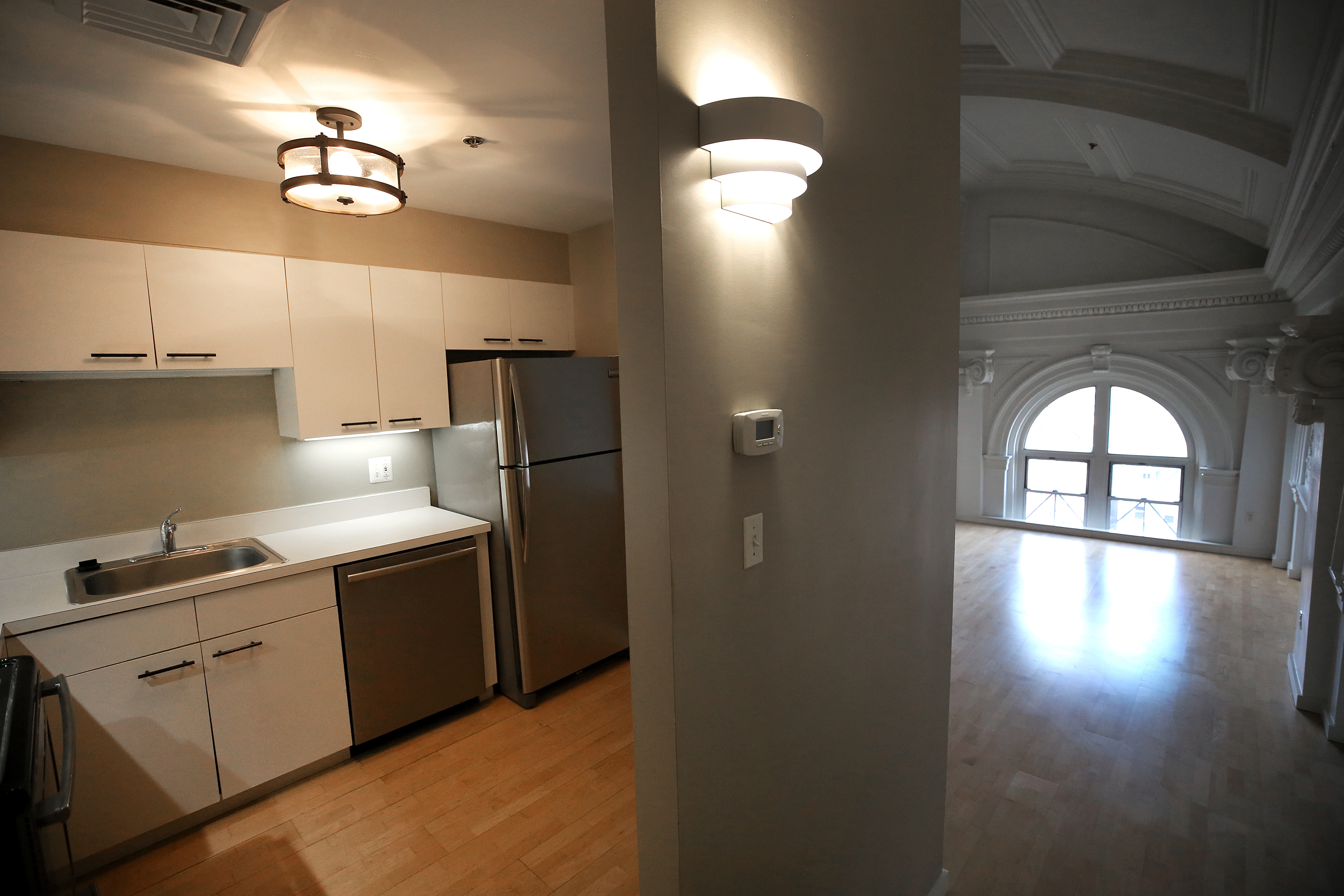 BOSTON, MA - 1/06/2021: 011721HOMEOFTHEWEEK....View of kitchen. Home of the Week is of an apartment for rent on the fourth floor of the old Charlestown High School in Boston. A small unit that has decorative walls and high ceilings because it used to be part of the auditorium. (David L Ryan/Globe Staff ) SECTION: BUSINESS