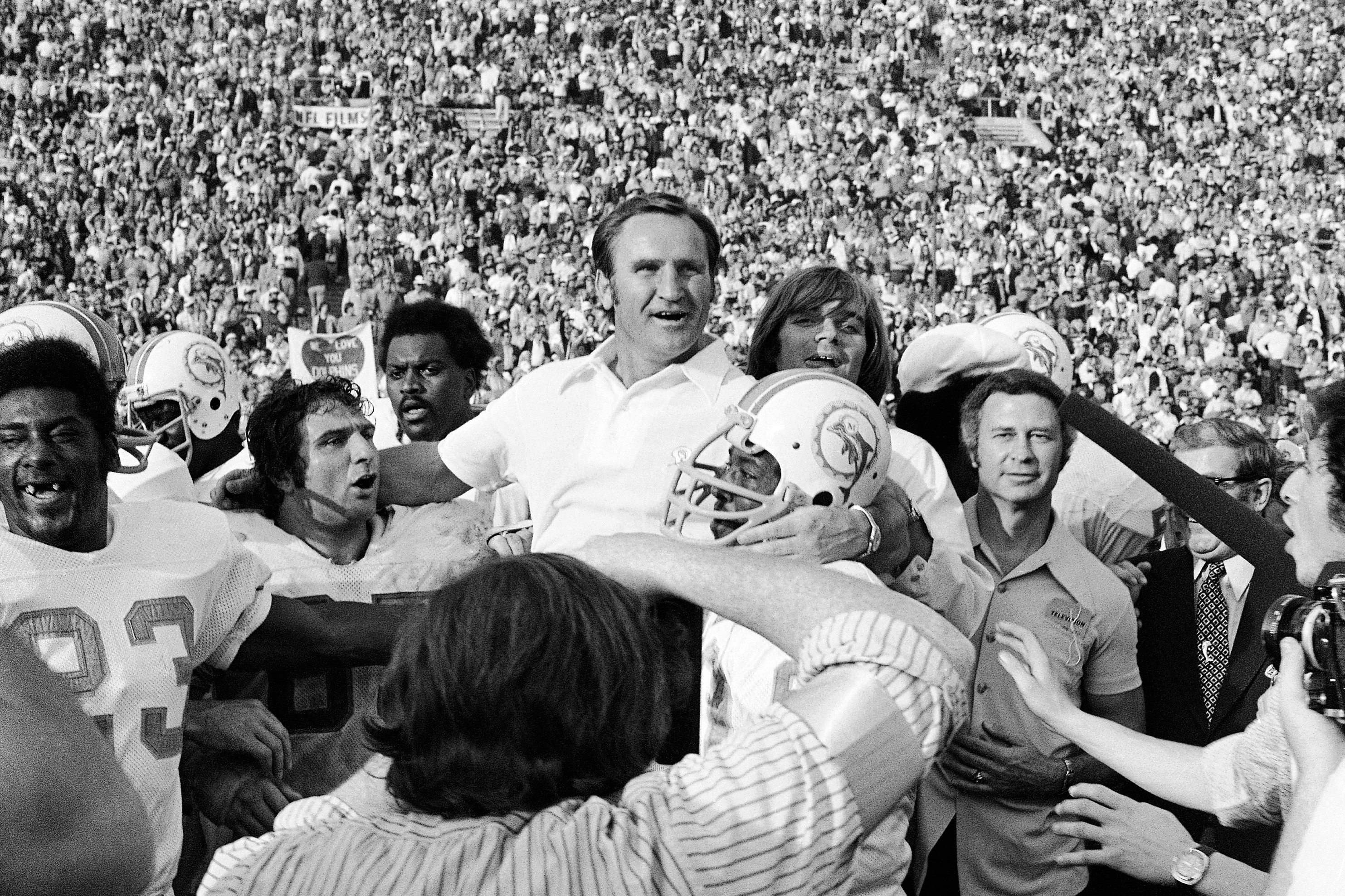 Don Shula is carried off by his players after the Dolphins completed their perfect season with a win over Washington in Super Bowl VII.