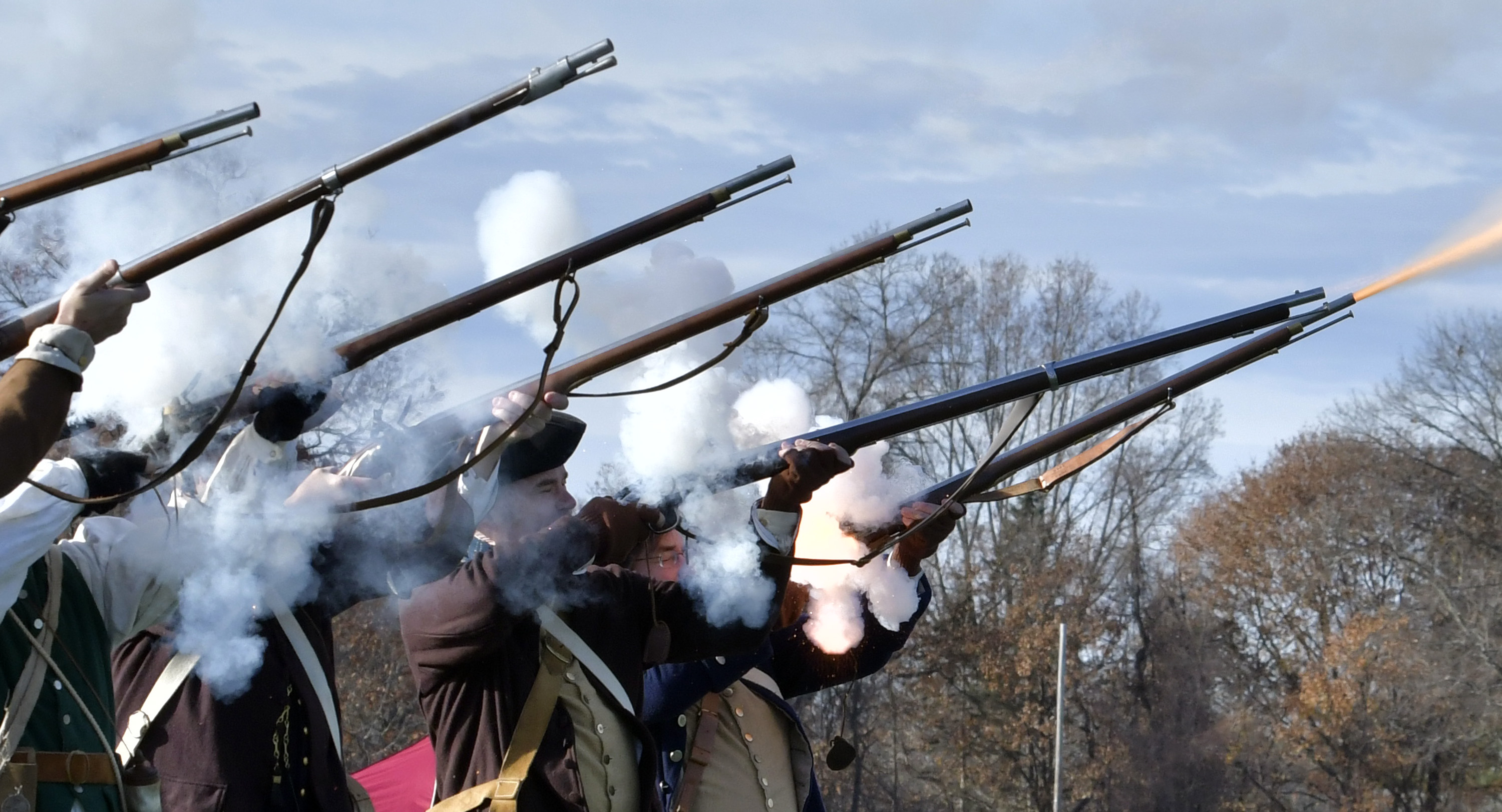 A line of Concord Minutemen fire a musket at the start of the game.