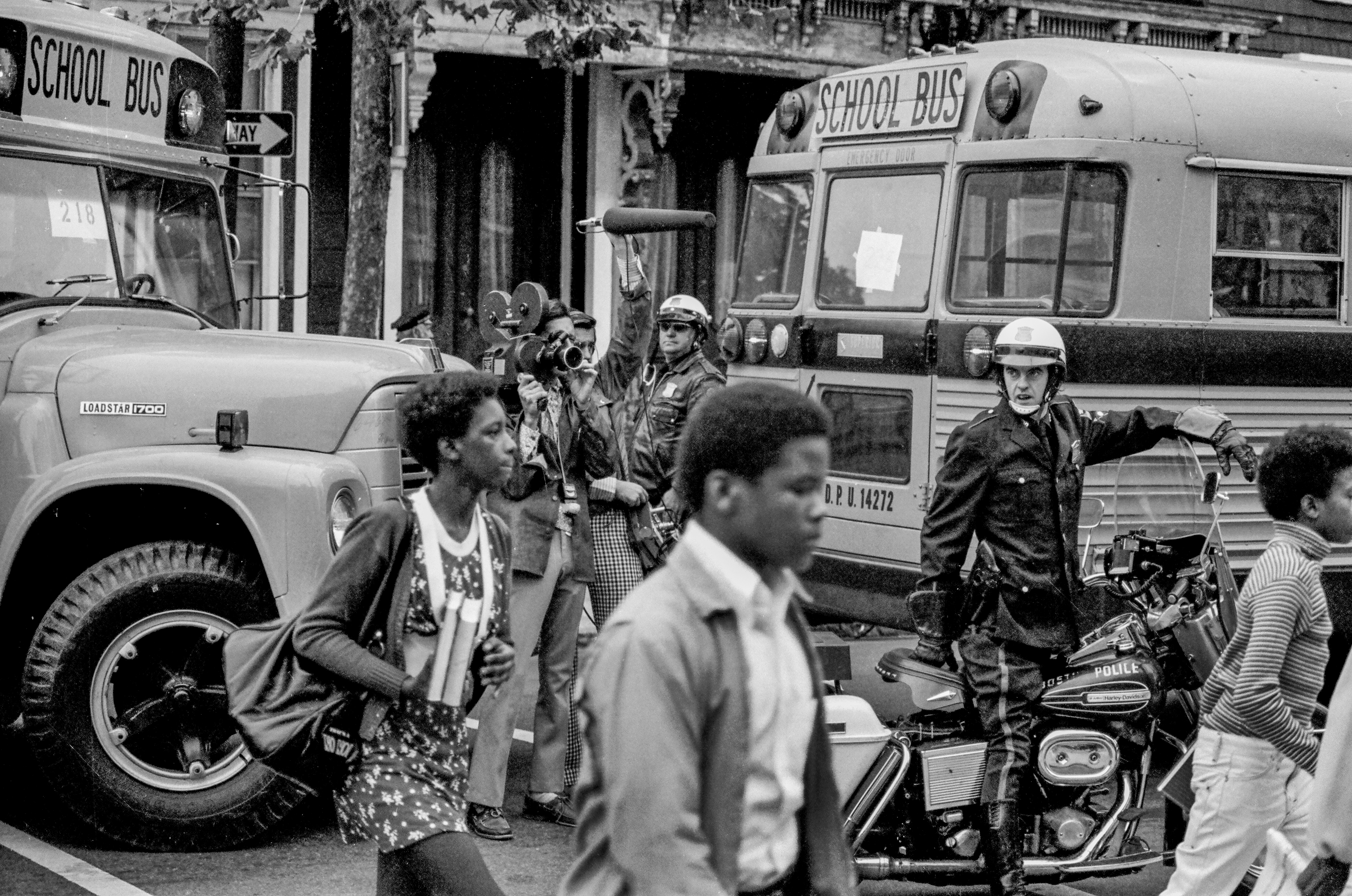 South Boston Heights Academy schoolchildren arrive with police escort at South Boston High School in 1974