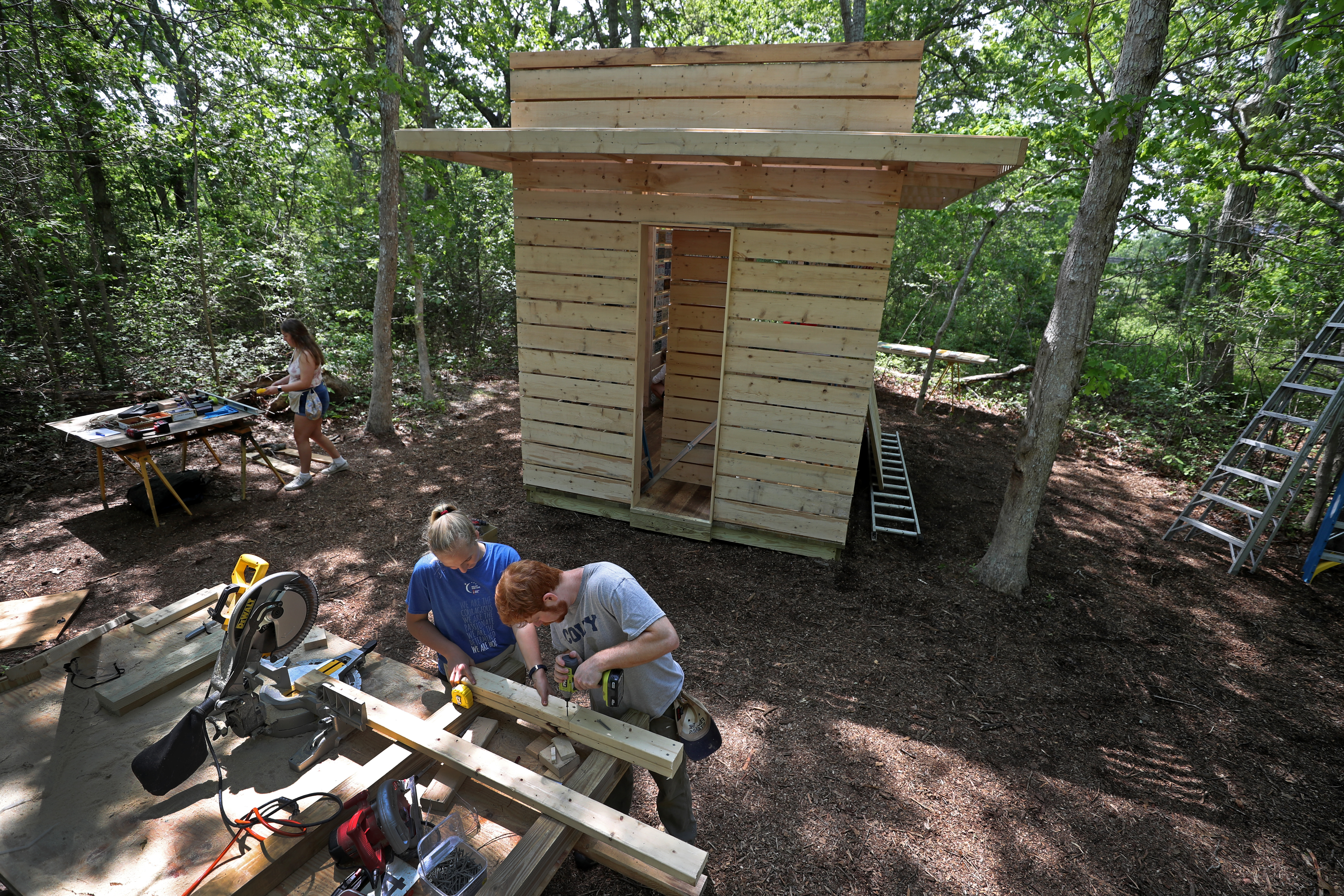 Architecture students Ellie Garside, left, and Ben Shapiro worked on the Studio North cabin on Tuesday.