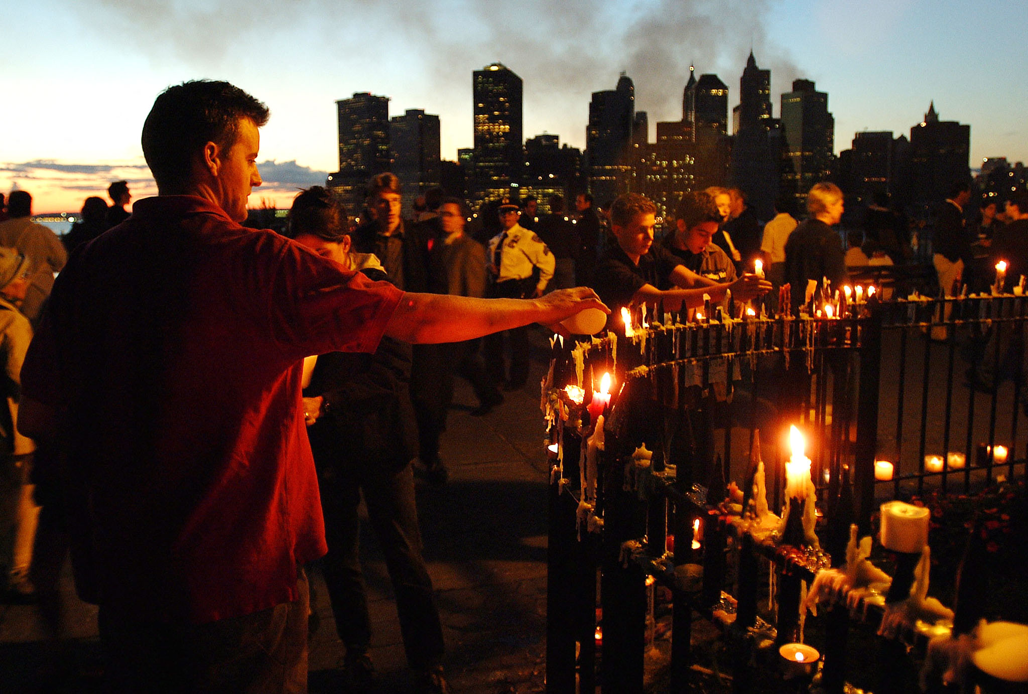 With the skyline of New York as a backdrop, people light candles on Sept. 14, 2001 to remember those lost in the World Trade Center attack.