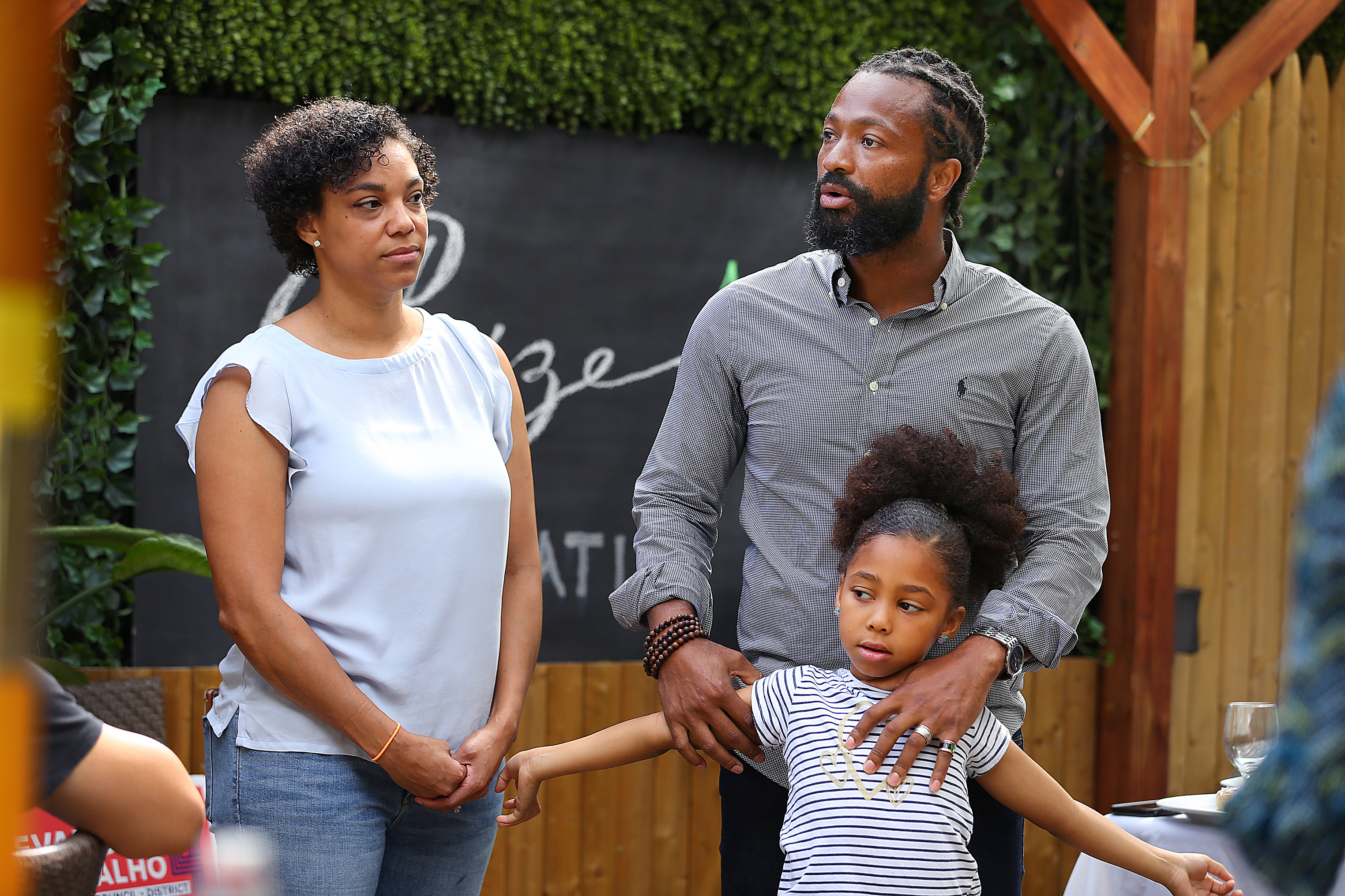 District Four candidate Evandro Carvalho spoke to volunteers at a campaign rally at Restaurante Cesaria in September. He stood with his eldest daughter, Eliana, 6, and his wife, Ashley.