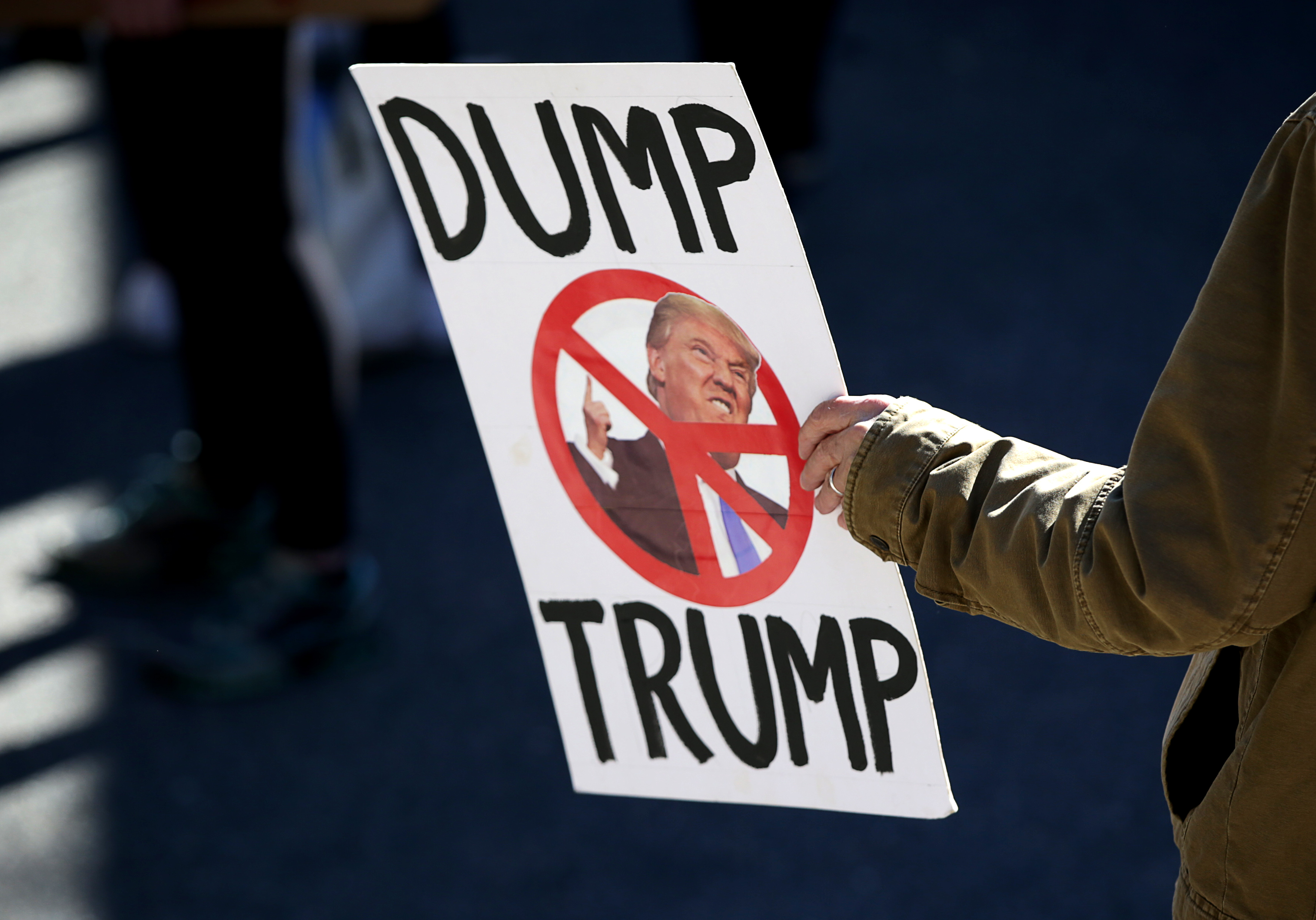 A person with their sign at a women's rally on Boston Common.