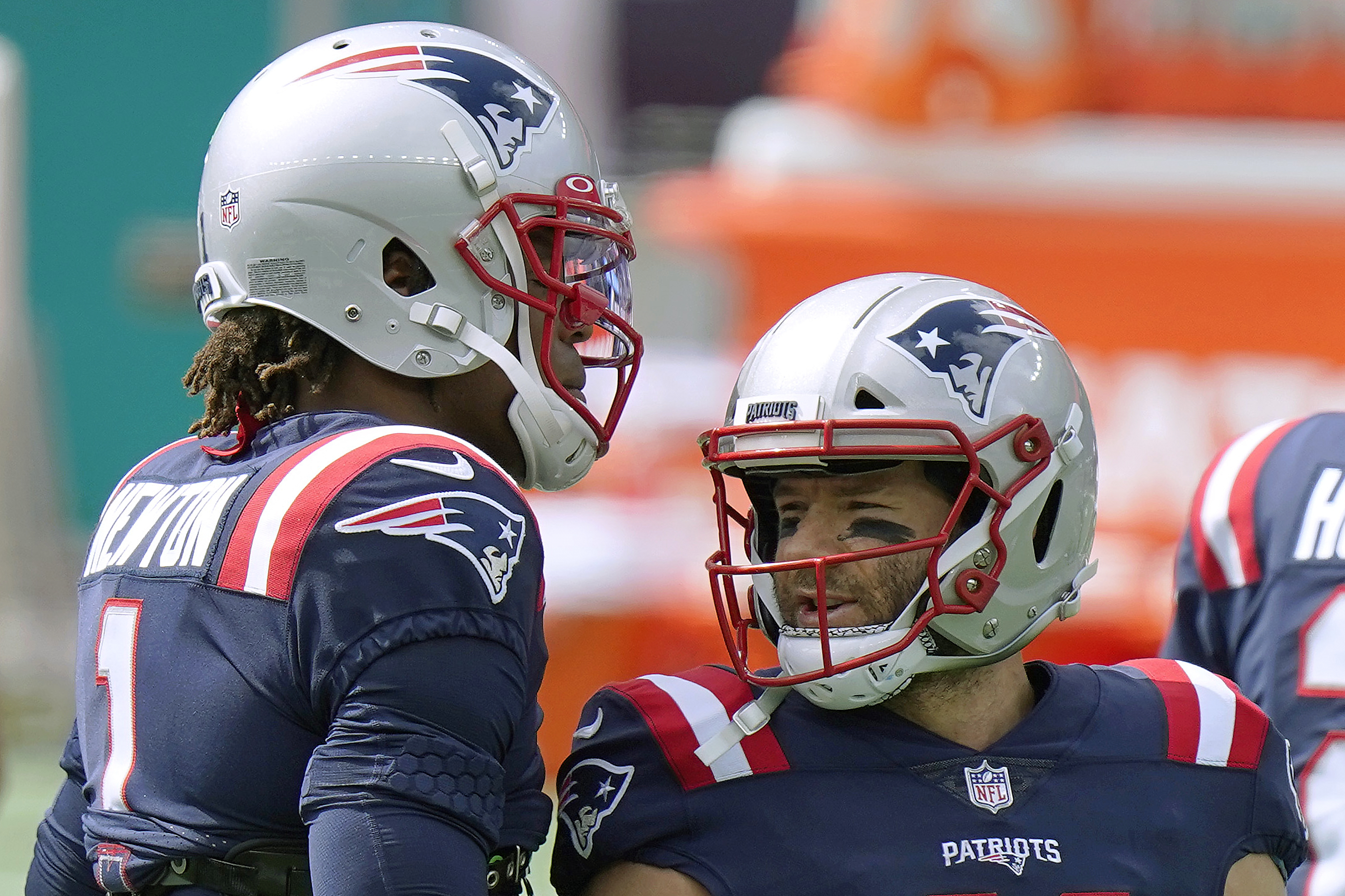 Cam Newton and Julian Edelman talk before a game earlier this year.