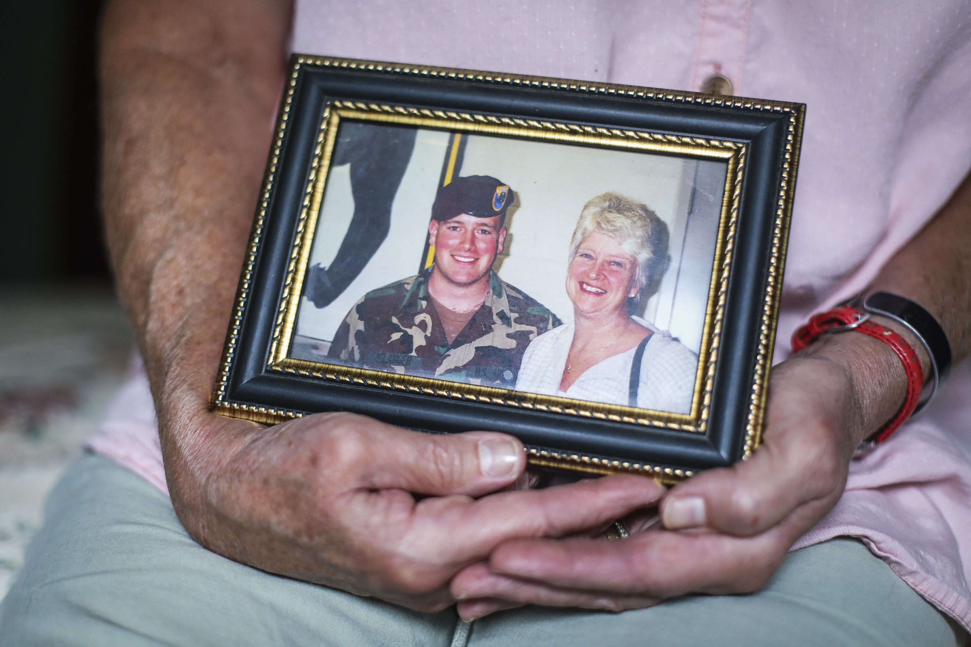Kathy Belanger held a framed photograph of her with her son Greg.