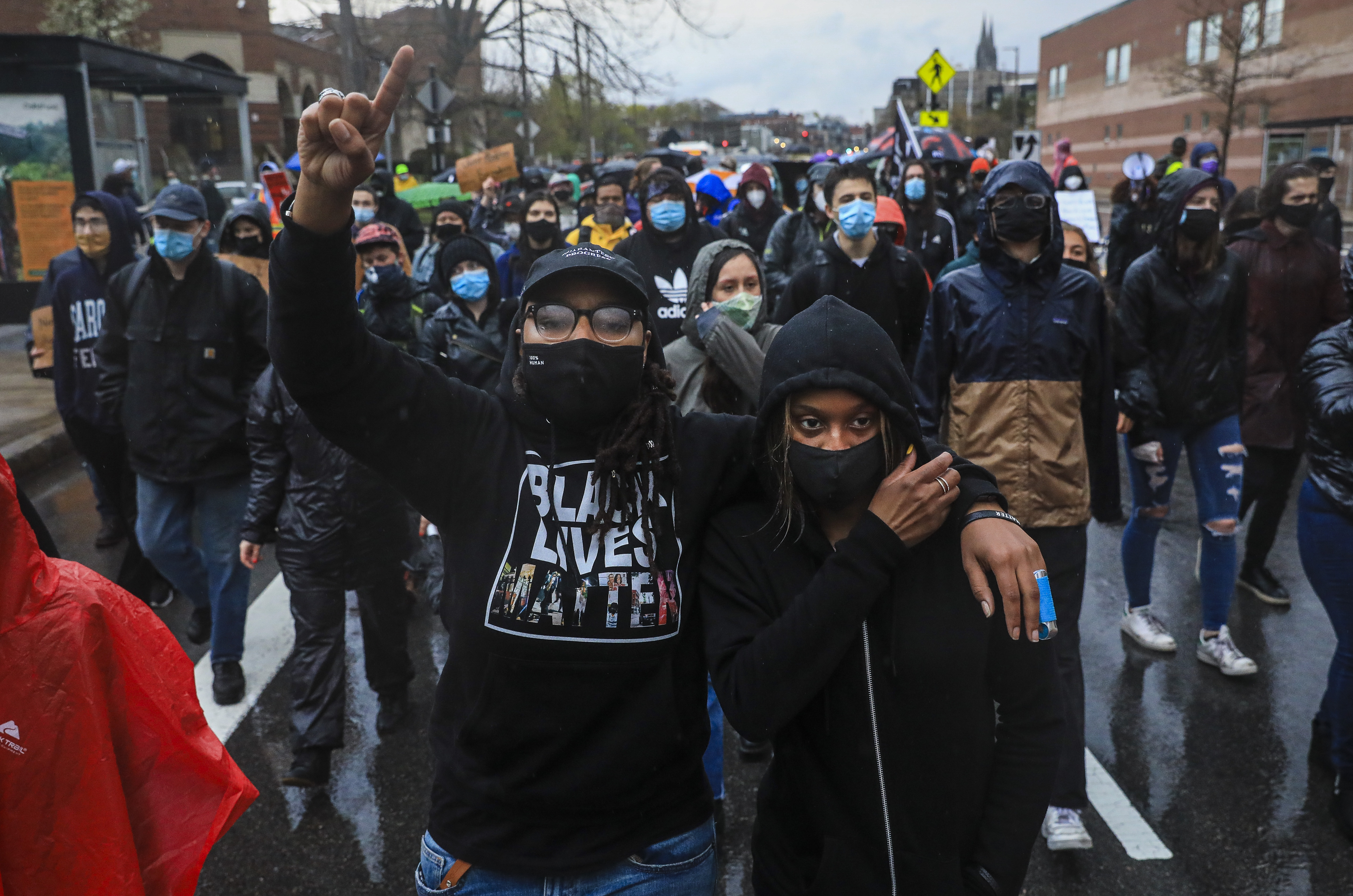 Bri Nichols (left) and Thatiana Desgraves marched with demonstrators through the rain from Nubian Square to Boston police headquarters calling for an end to police brutality and improved race relations.