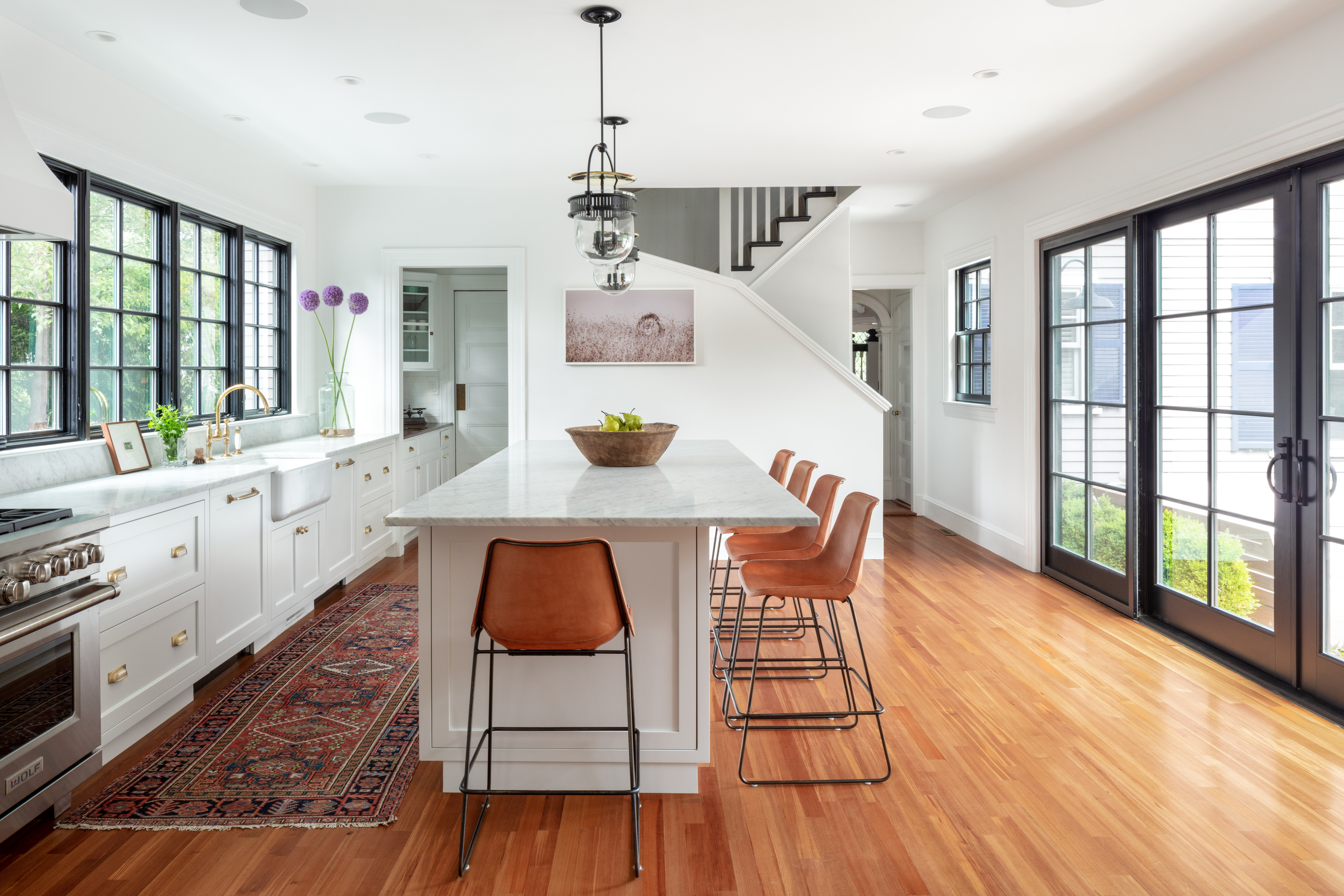 The client requested a white kitchen with Carrara marble countertops. “She understood it would get etchings and was OK with it,” McGuill says. “You need to embrace the patina.”
