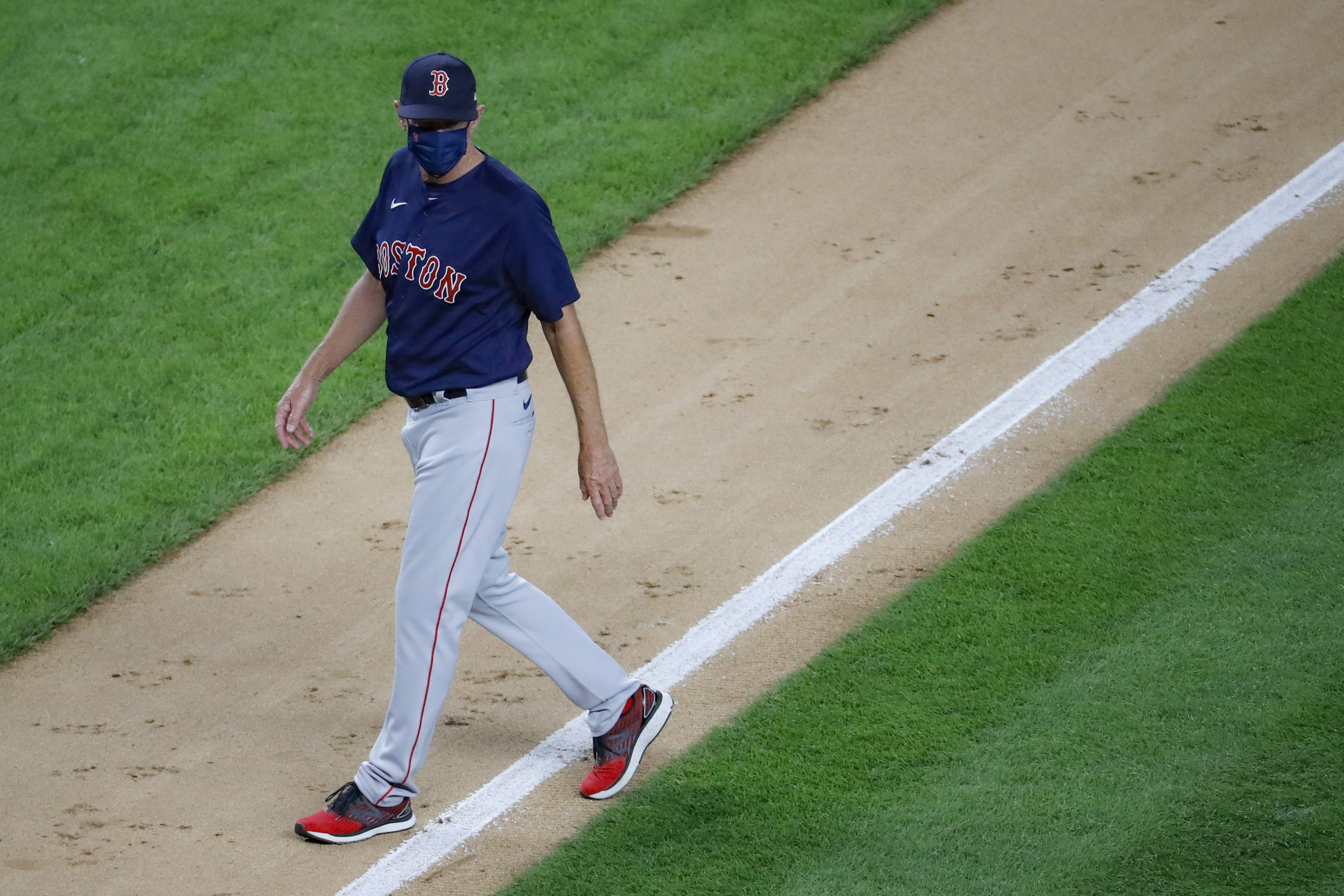 Ron Roenicke walks back to the dugout after removing starting pitcher Zack Godley during the fourth inning of Saturday's game.