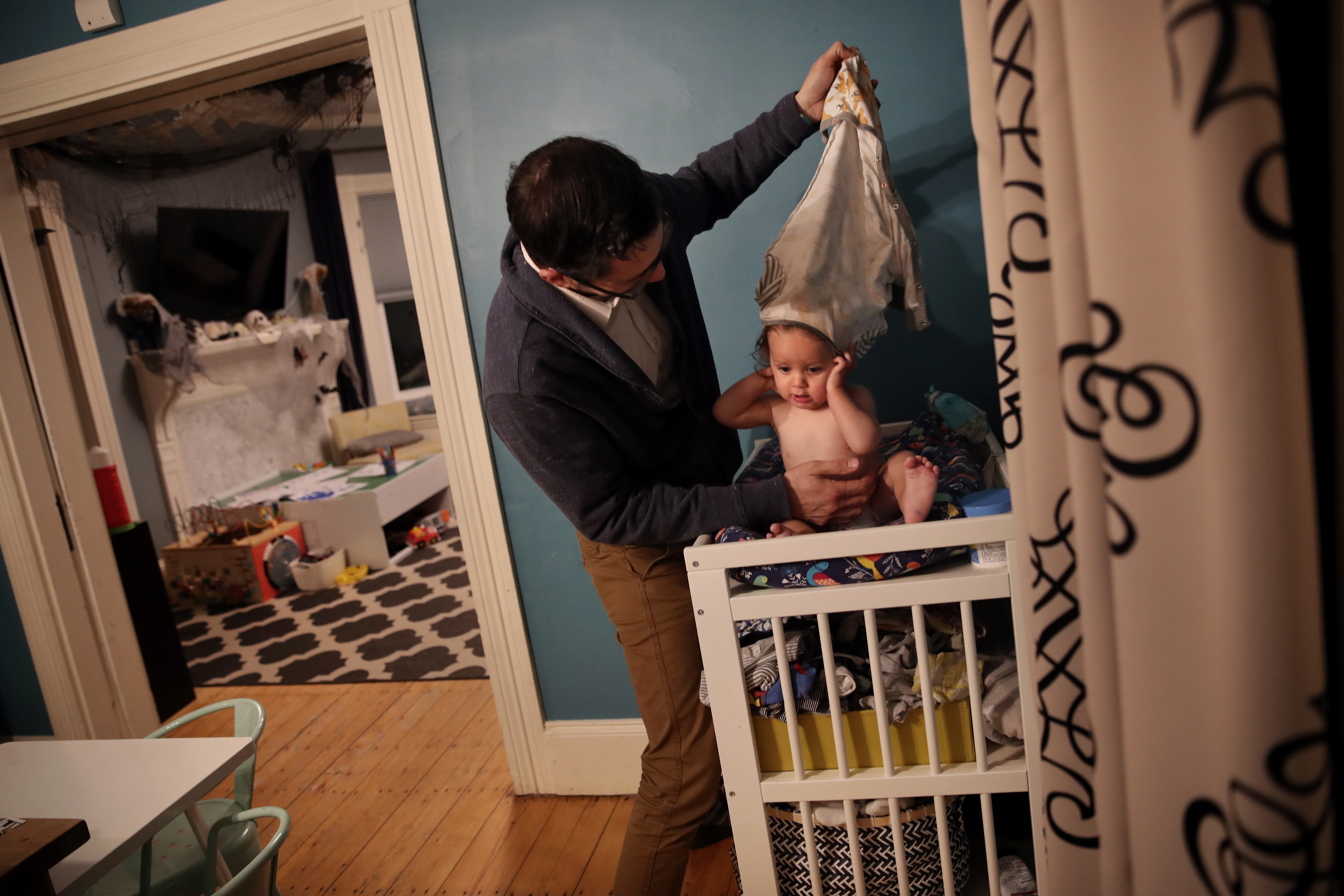 Dan Giacalone dressed his son Gus, 10 months, before bedtime at their home in Dedham. Dan and Raelee Giacalone know a lot about hunting for changing stations in public: They have four kids. Proposed legislation would require new public buildings, or those being substantially renovated, to include diaper changing stations accessible to all genders and disabled people.