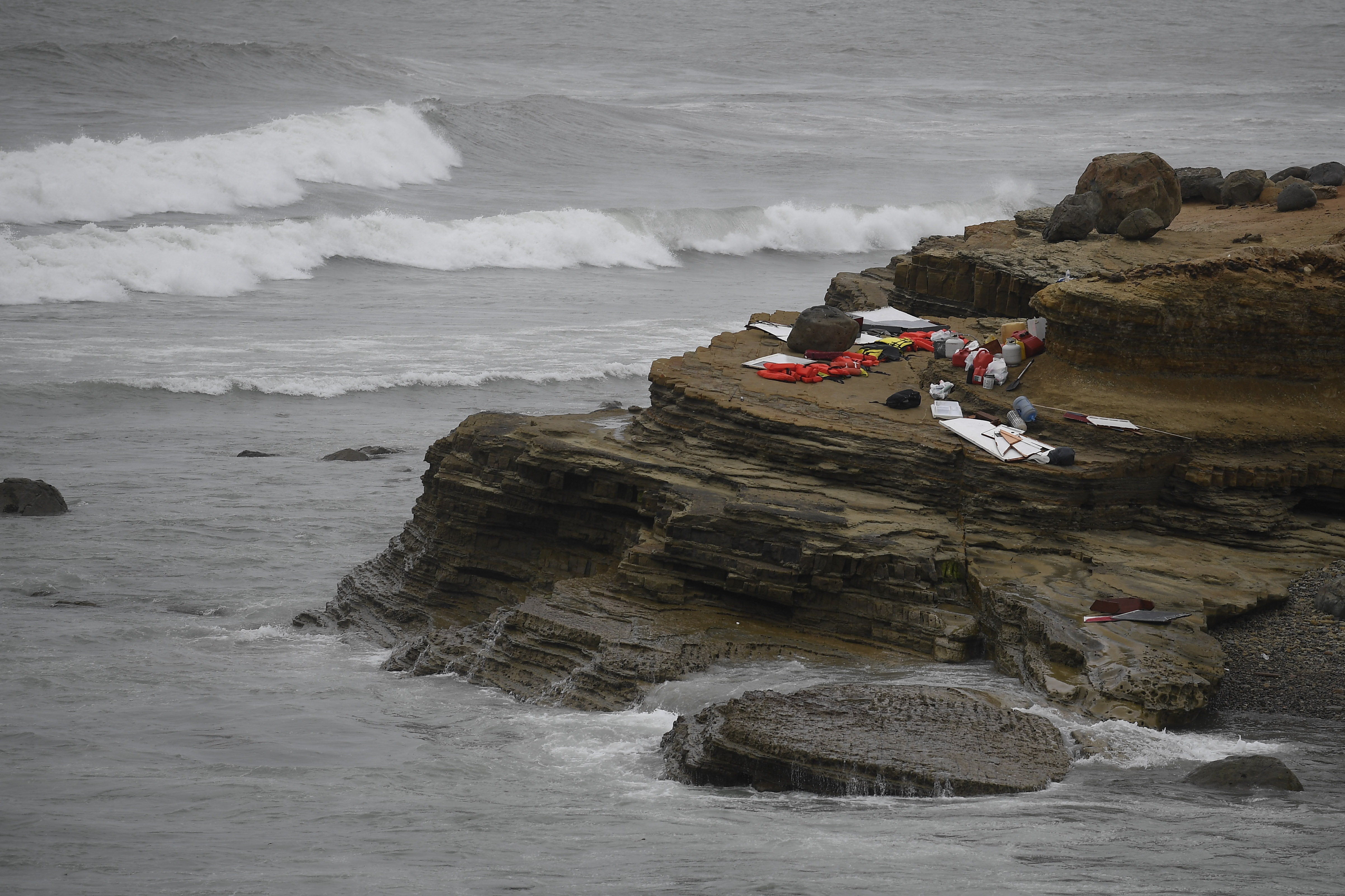 Items from a boat sit on the shoreline at Cabrillo National Monument near where it capsized just off the San Diego coast Sunday, May 2, 2021, in San Diego.
