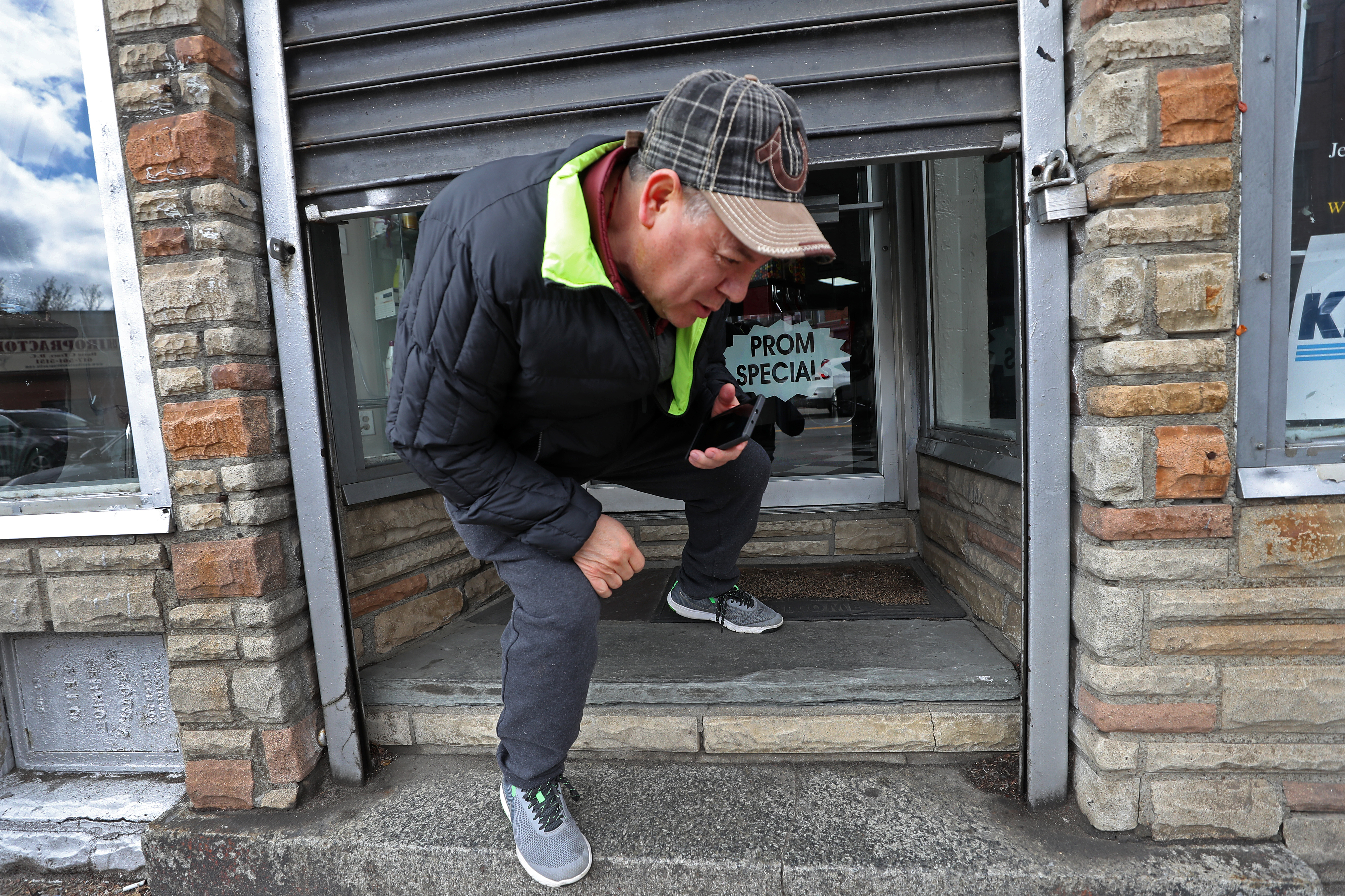 BOSTON, MA - 3/24/2020: Raphael Aguirre shuts down his hair salon that he has owned for 15 years in East Boston. Businesses deemed non-essential closed their doors at noon today.(David L Ryan/Globe Staff ) 