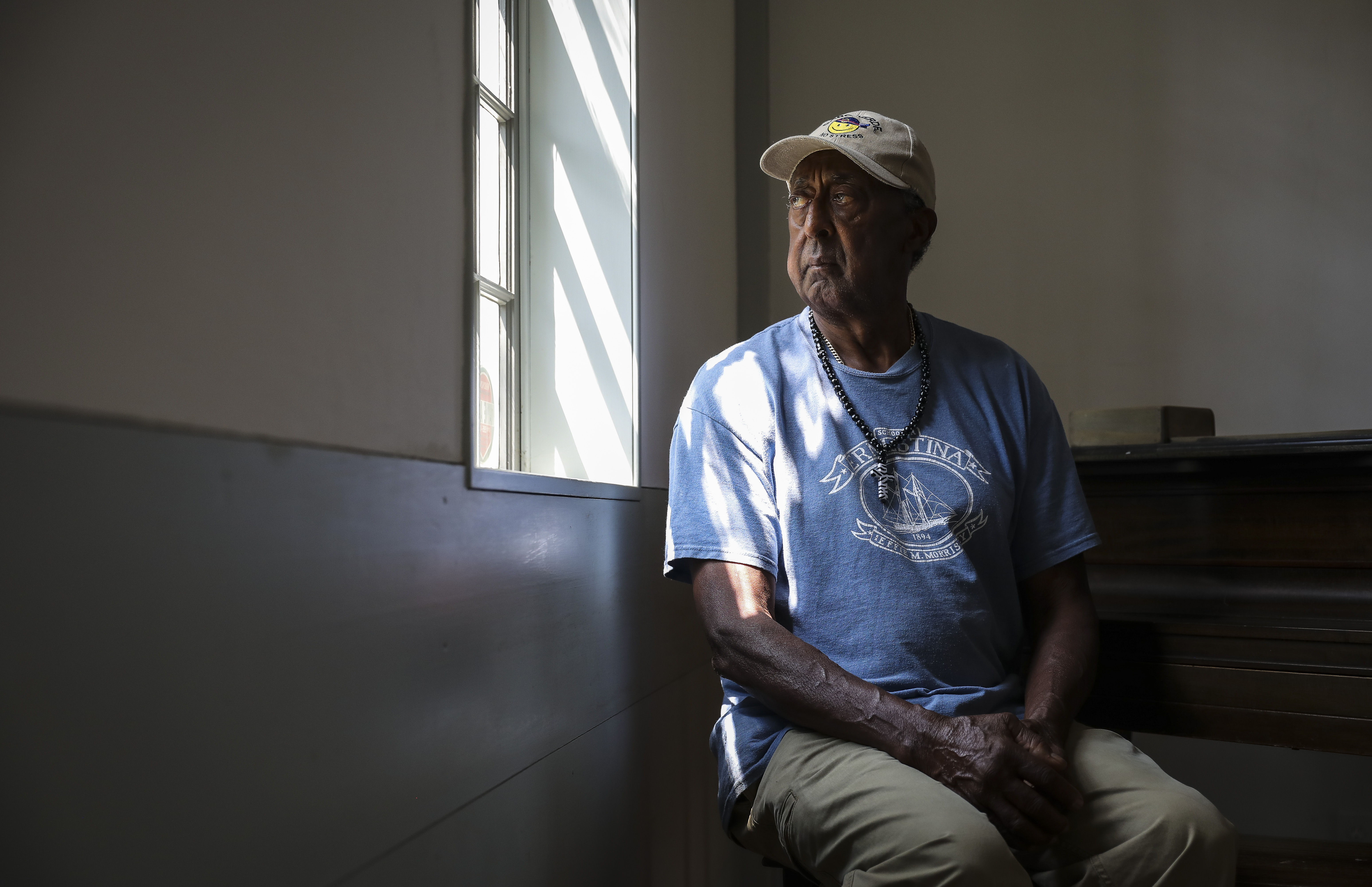 Jim Barros sits in the Nantucket African Meeting House, which was vandalized with racial slurs in March 2018.