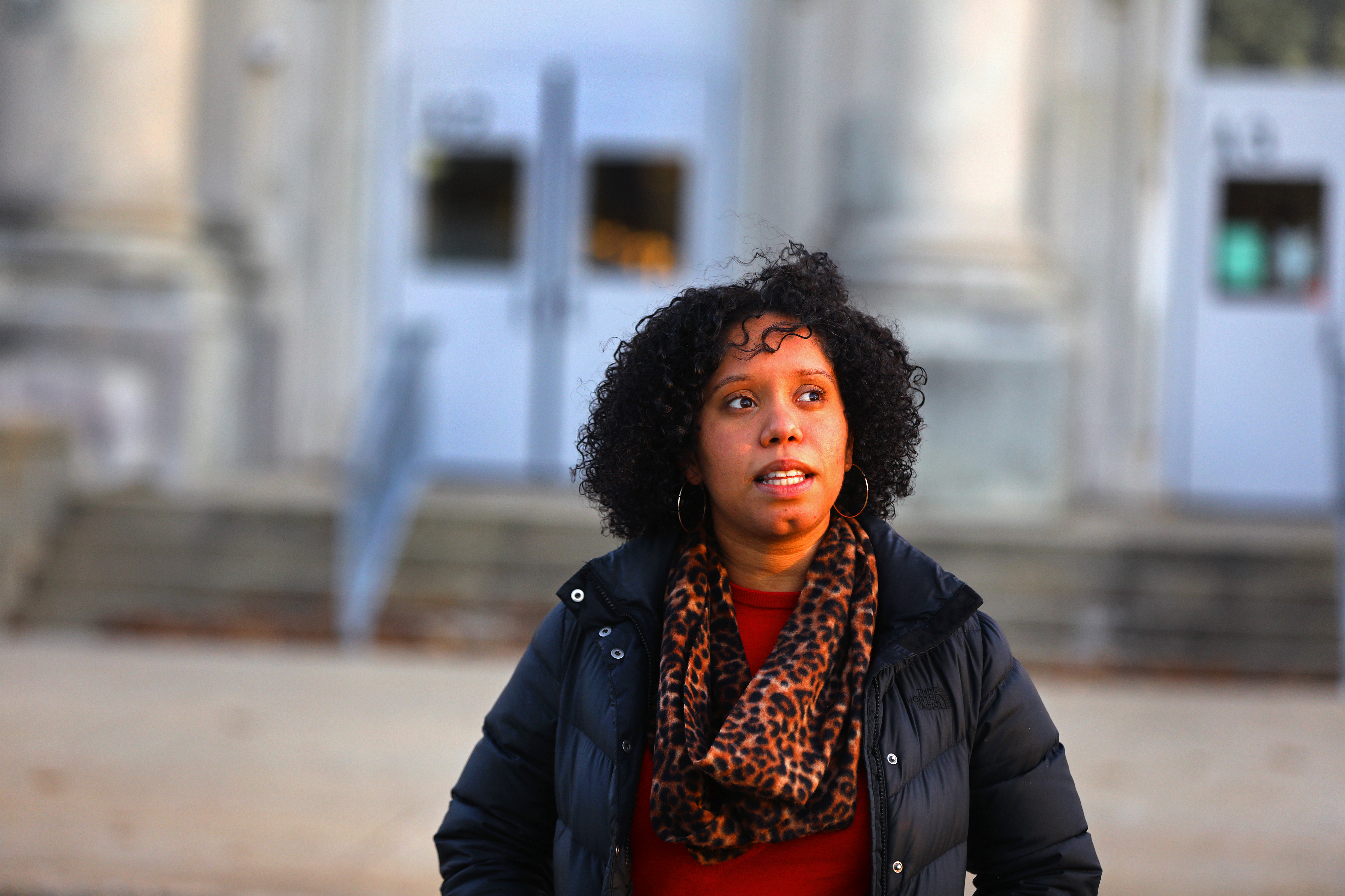 Raisa Ferreras stands outside her old high school, Lynn English. About half of Lynn's high school graduates go on to college. Half do not.