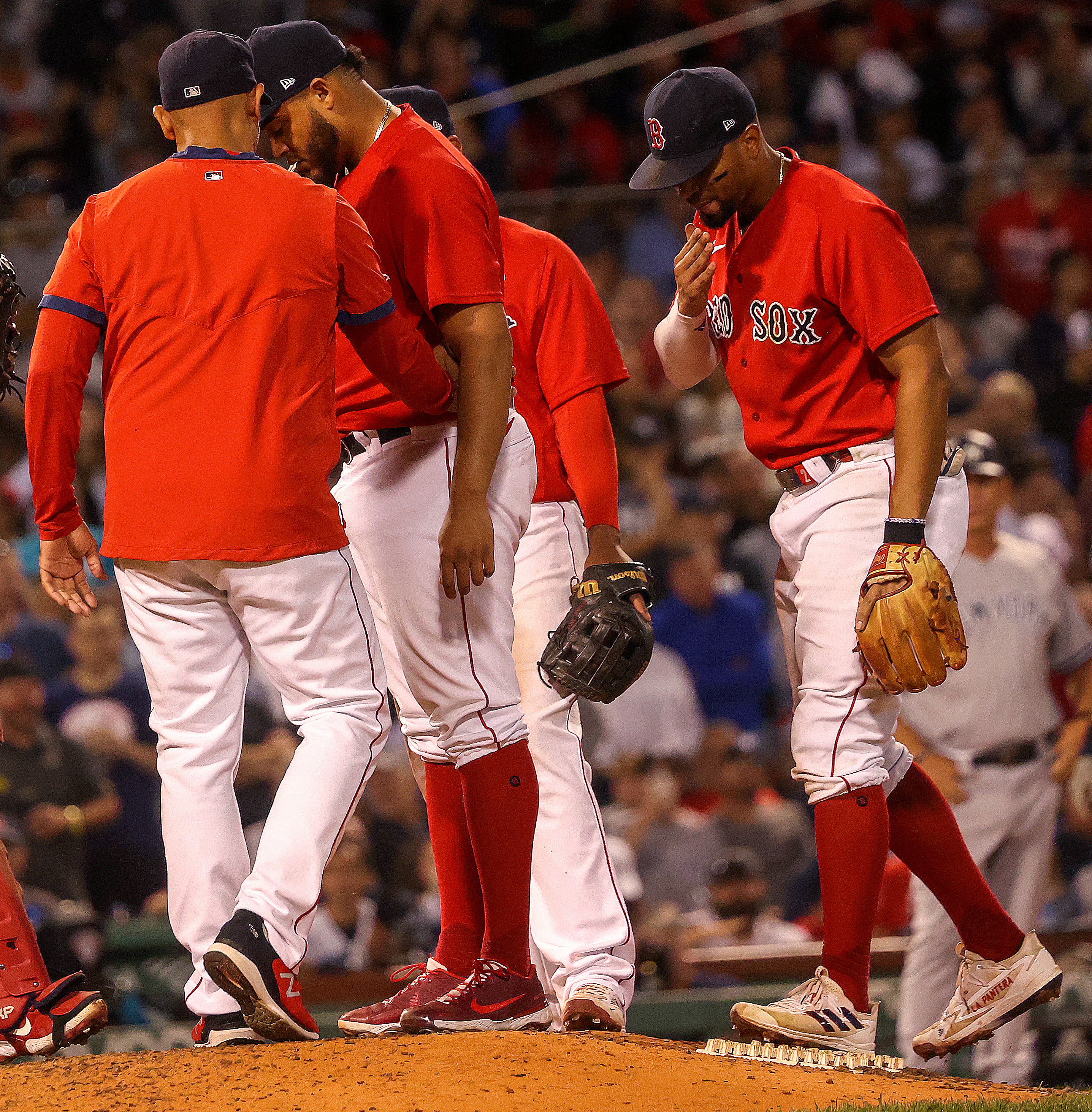 Red Sox manager Alex Cora has a mound conference with relief pitcher Darwinzon Hernandez right before the pitcher's next pitch to Yankees' designated hitter Giancarlo Stanton (27) for a Grand Slam.