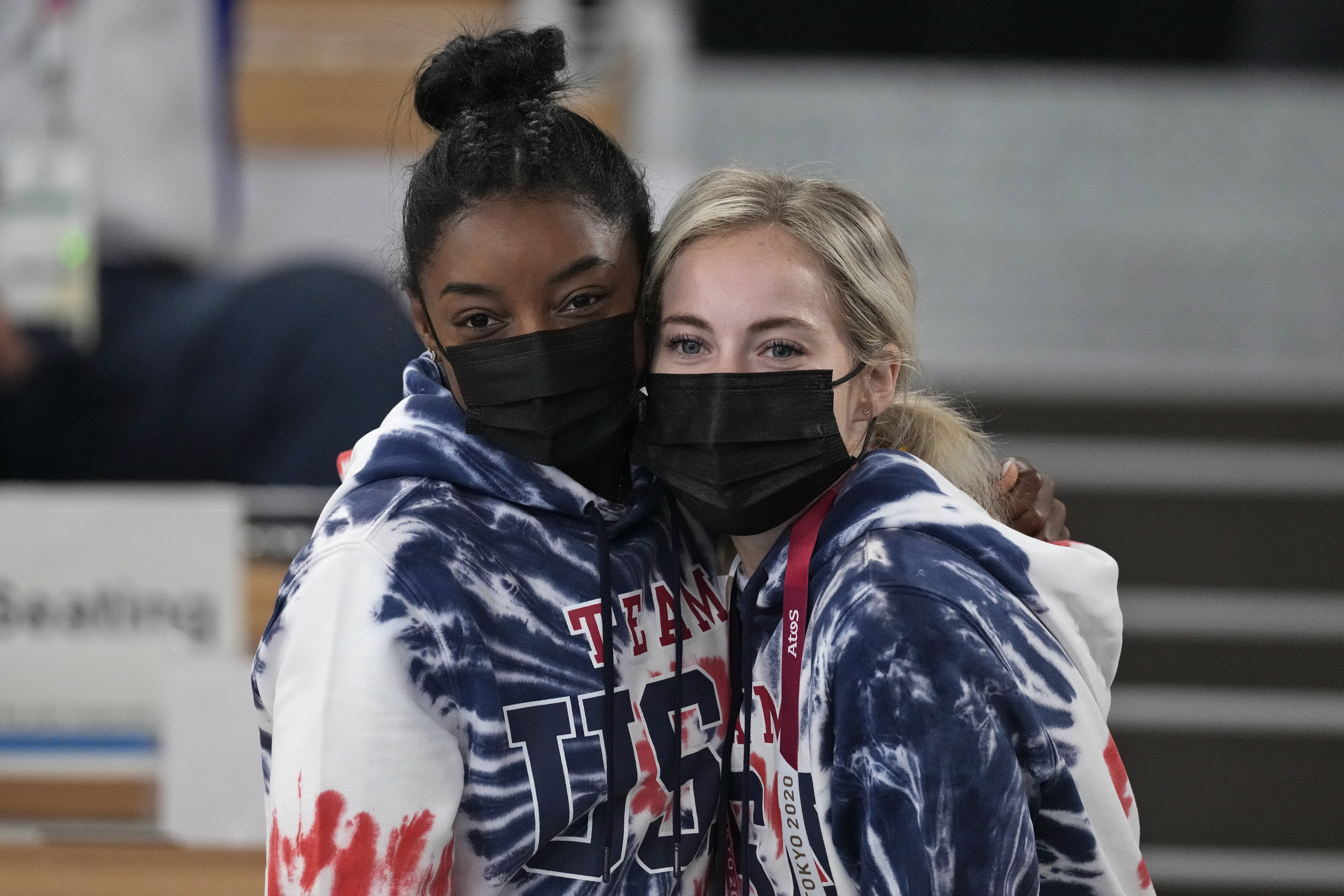Simone Biles and teammate Mykayla Skinner watch the artistic gymnastics men's all-around final Wednesday in Tokyo.