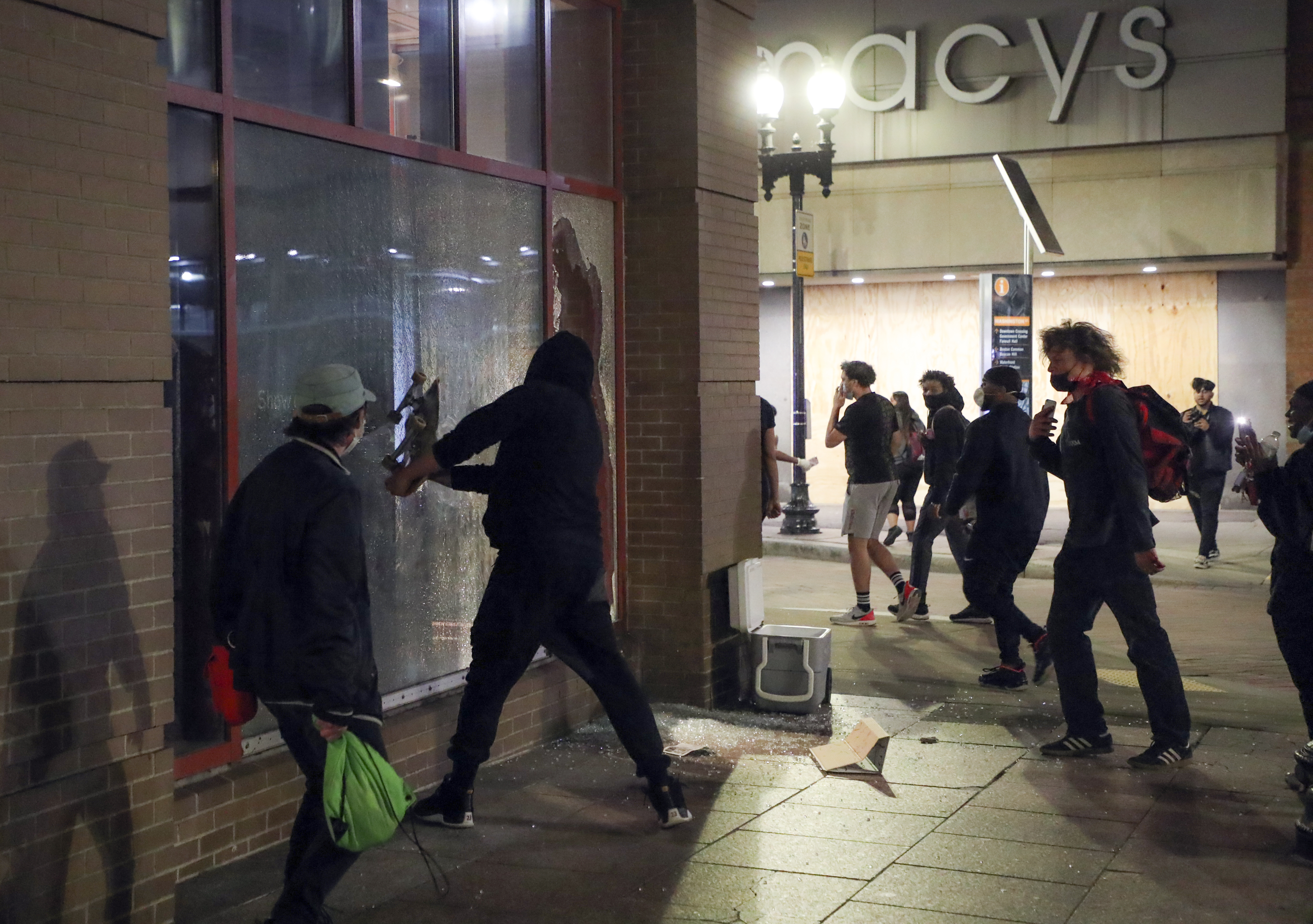A protestor broke the windows of a Men’s Warehouse store with his skateboard in Downtown Crossing.