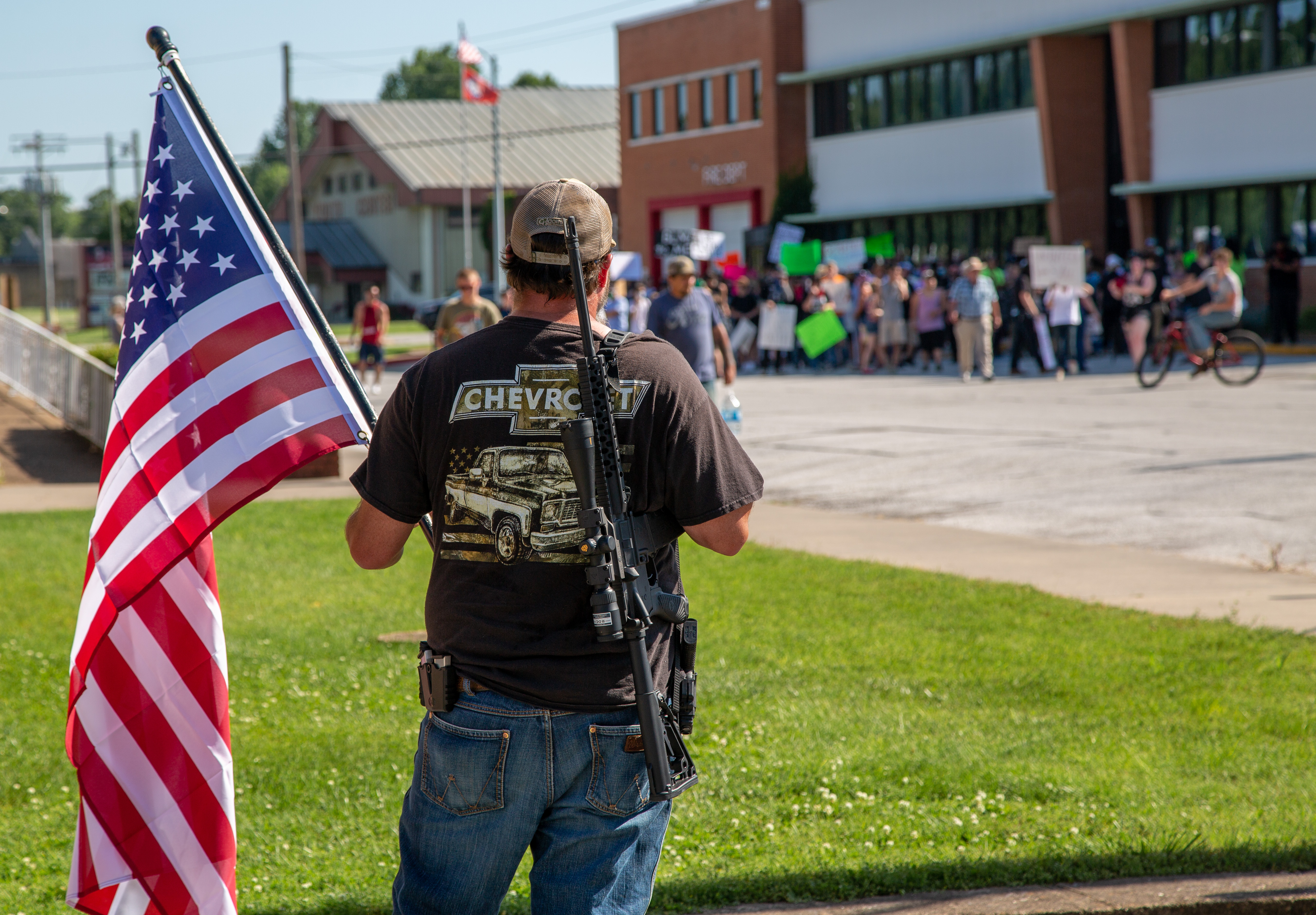 An armed man waited for the protest to arrive in downtown Harrison.
