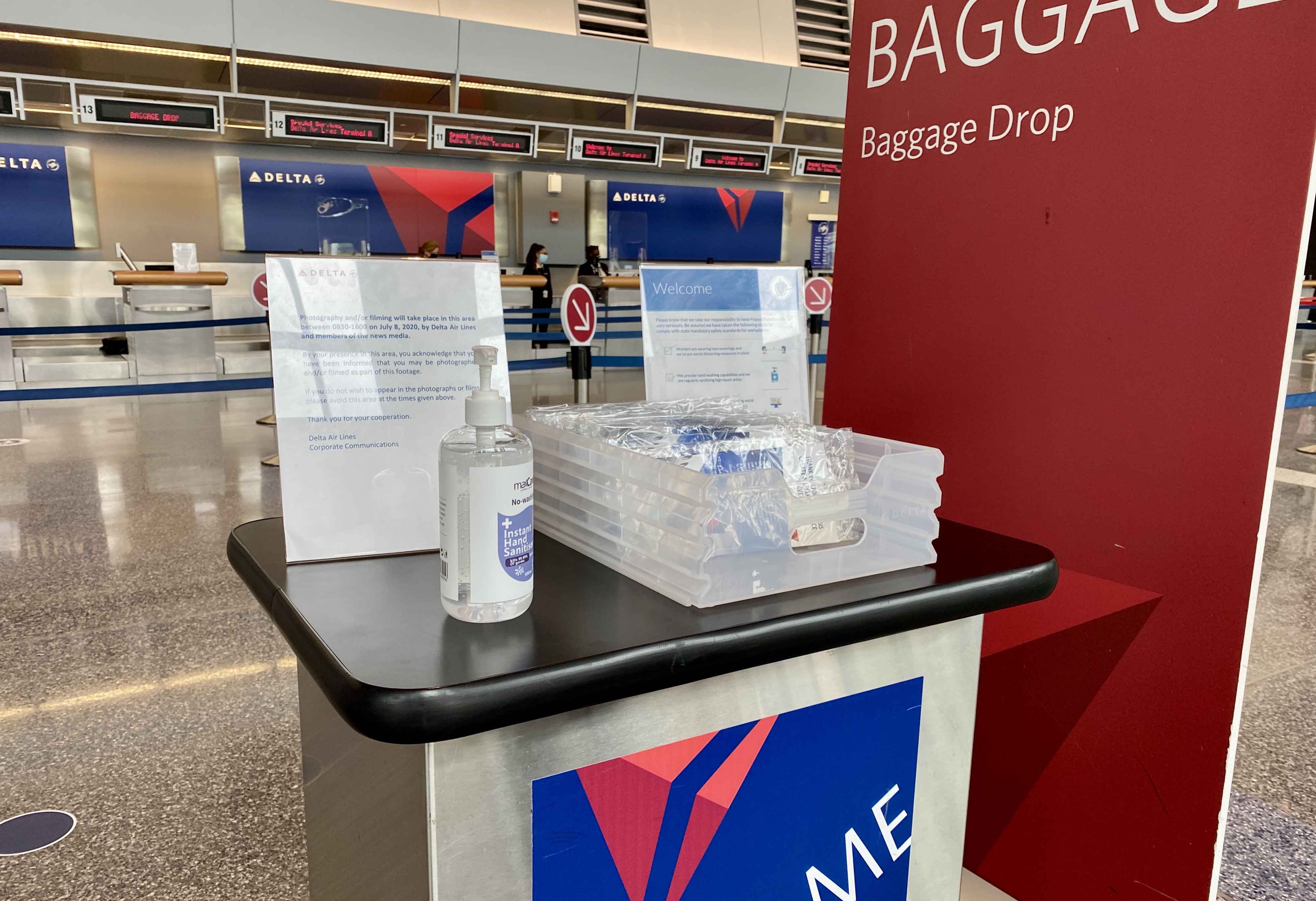 Face masks were available to passengers at a kiosk in the Delta terminal at Logan.