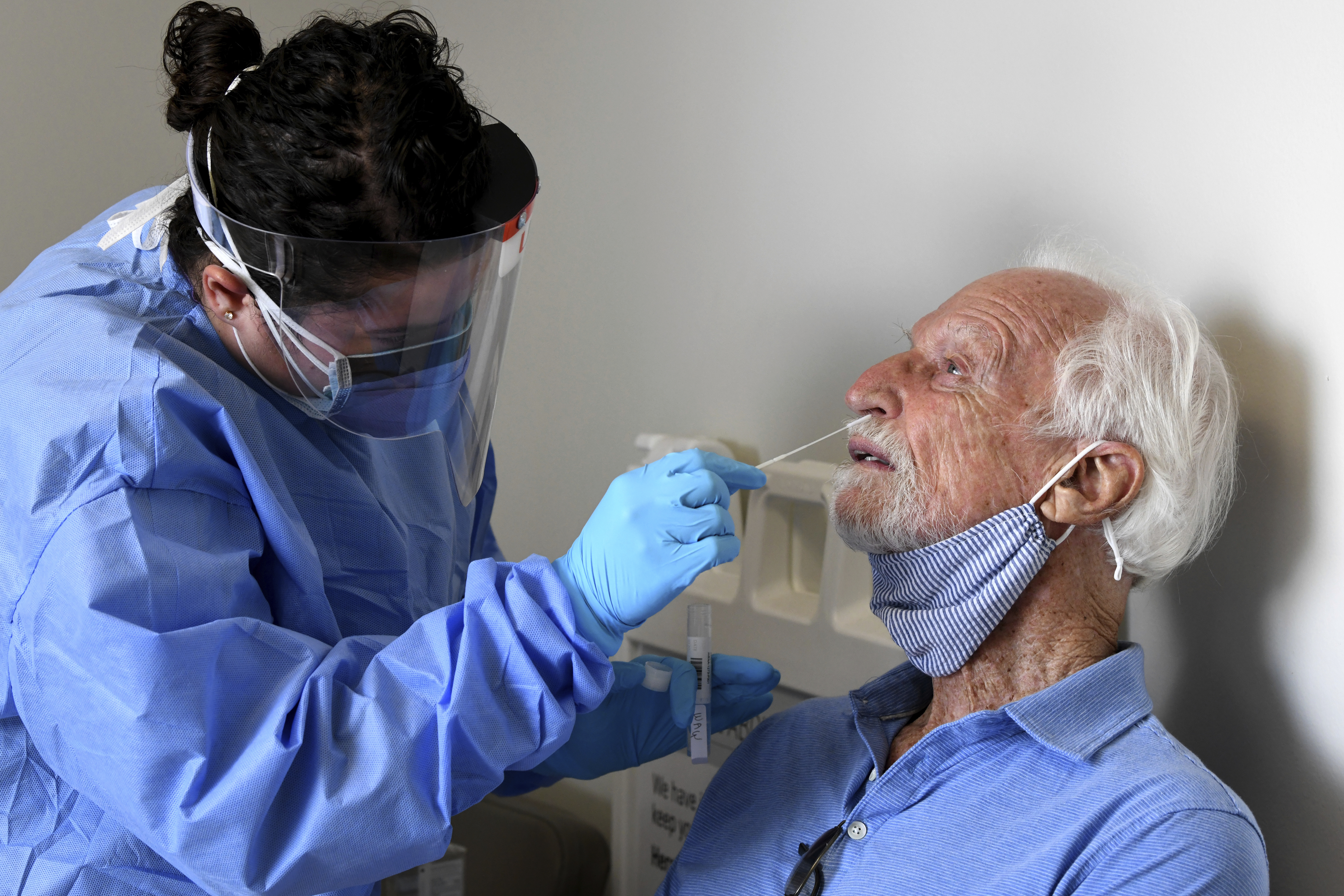 NIH-funded Moderna vaccine study participant William Webb got a nose swab by University of Miami Miller School of Medicine nurse Loreta Padron in Miami last month.