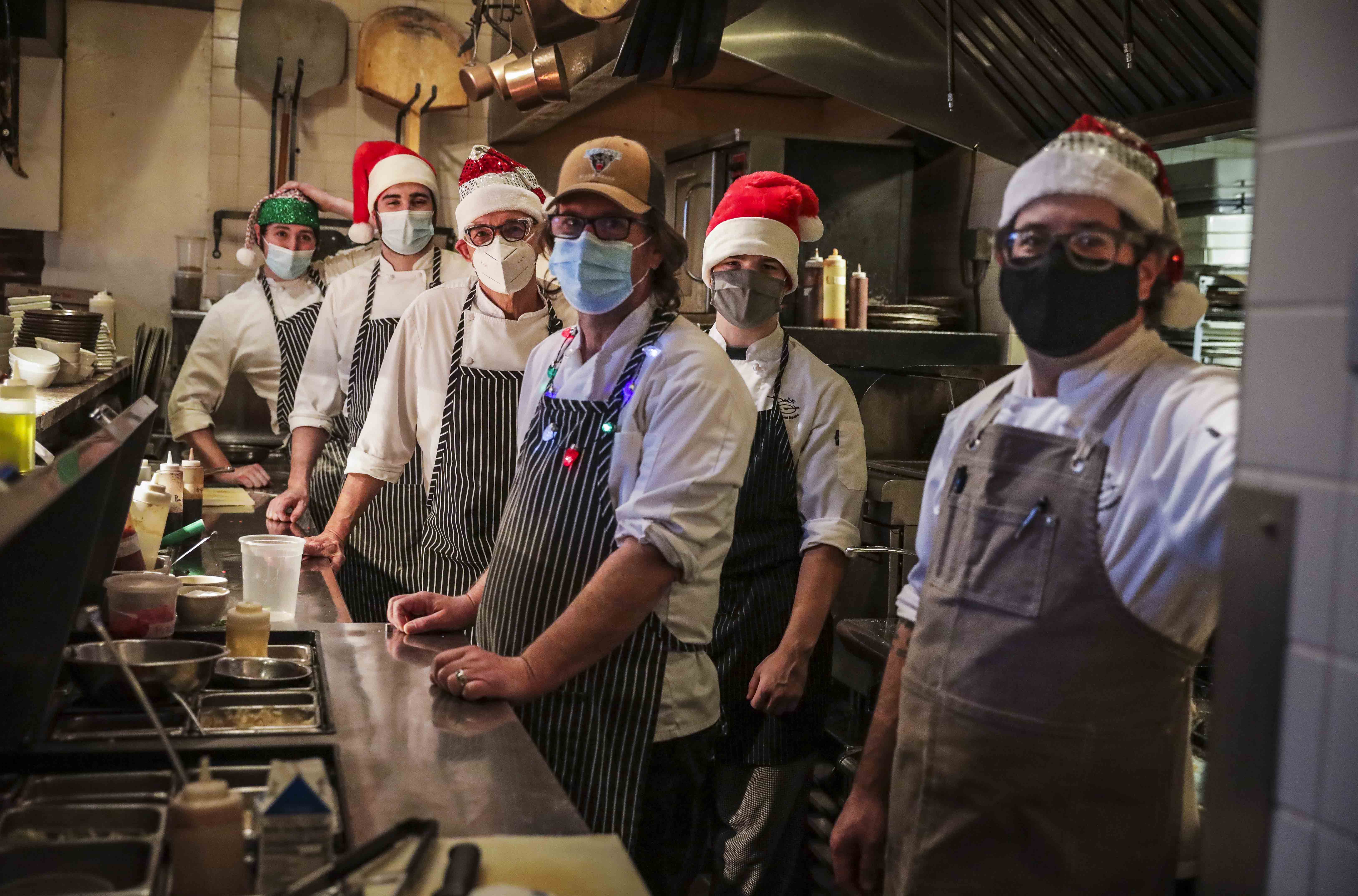 David Turin (center), who owns three restaurants, stood with his chefs in his kitchen.