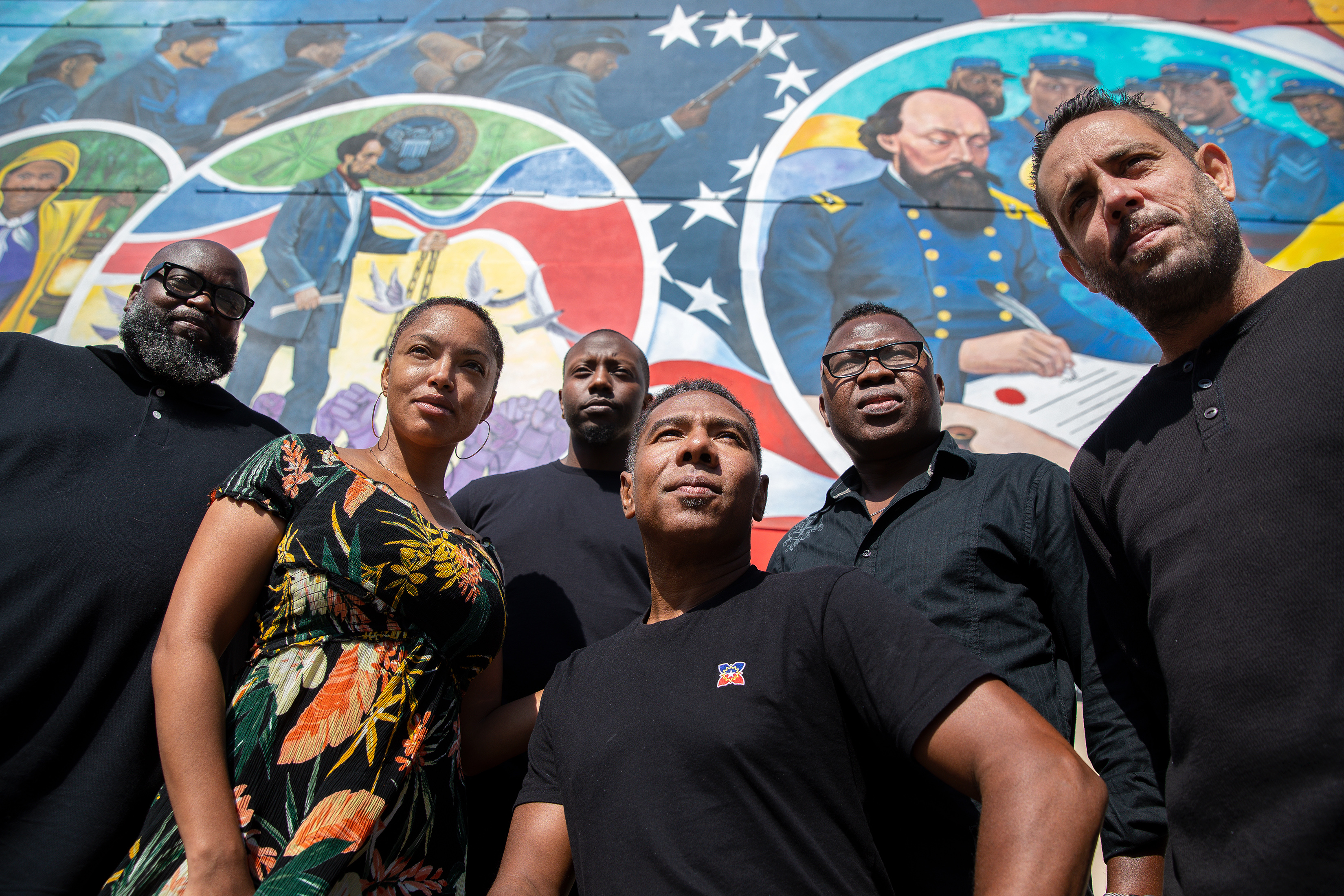 Reginald Adams, center, with his creative team, in front of his a 5,000-square-foot mural, entitled “Absolute Equality,” in Galveston, Texas, on May 5, 2021.