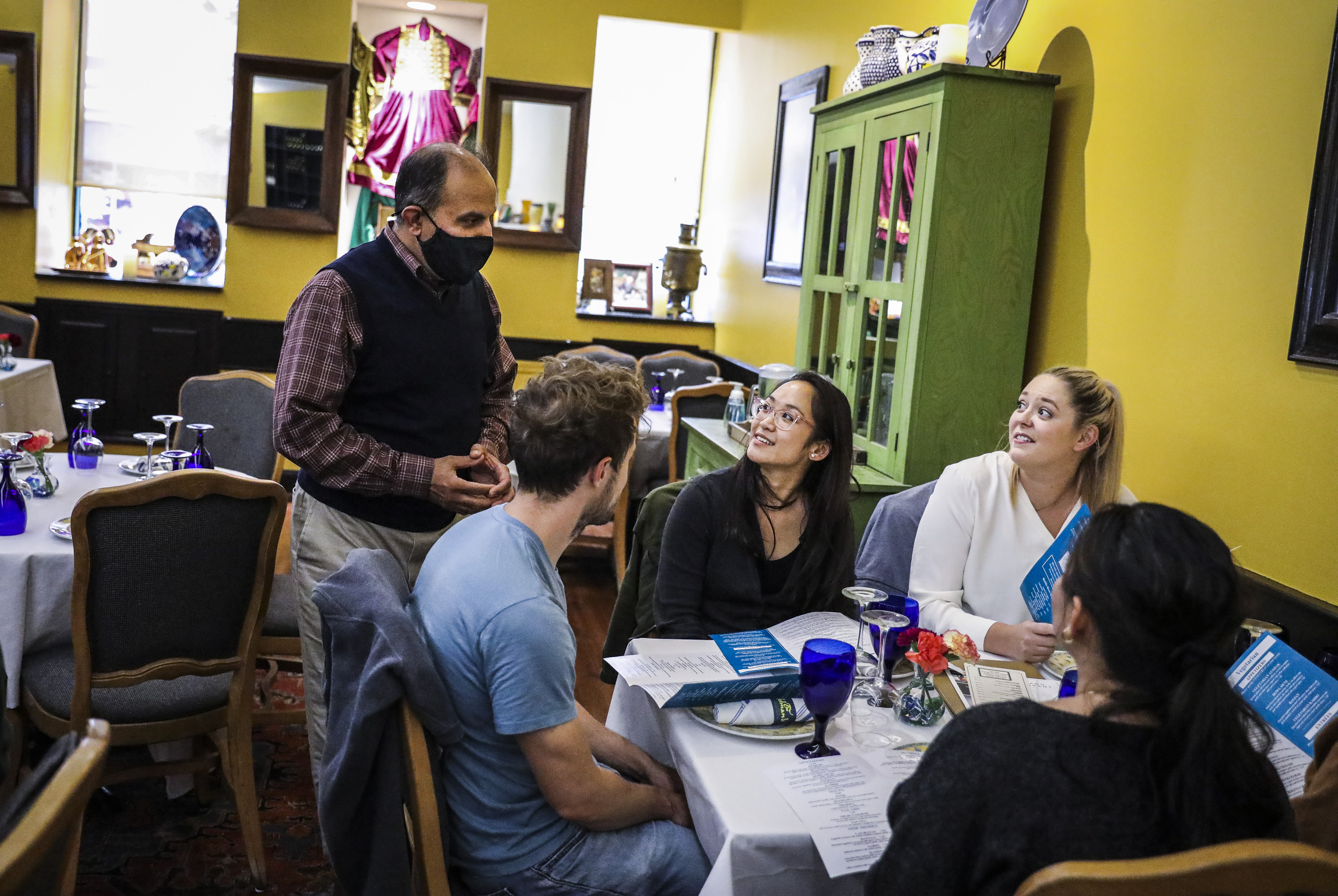 Ali Tokhi waited on a table at his restaurant in Cambridge.