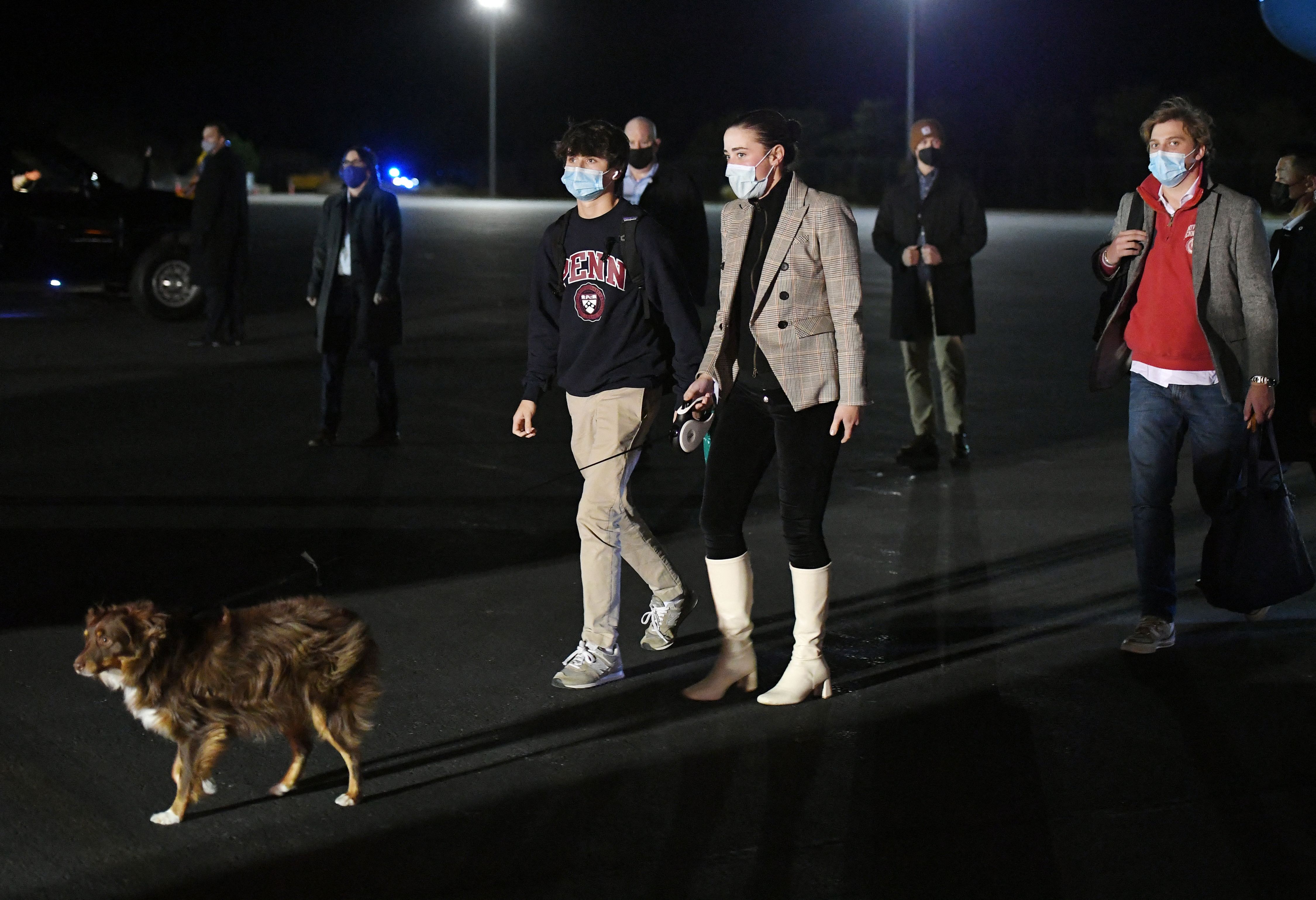 The grandchildren of President Joe Biden, Naomi Biden, her fiance Peter Neal (R), (C) and Robert Hunter Biden (L) walked with Naomi's dog Charlie upon arrival at Nantucket Memorial Airport in Nantucket on Nov. 23, 2021.
