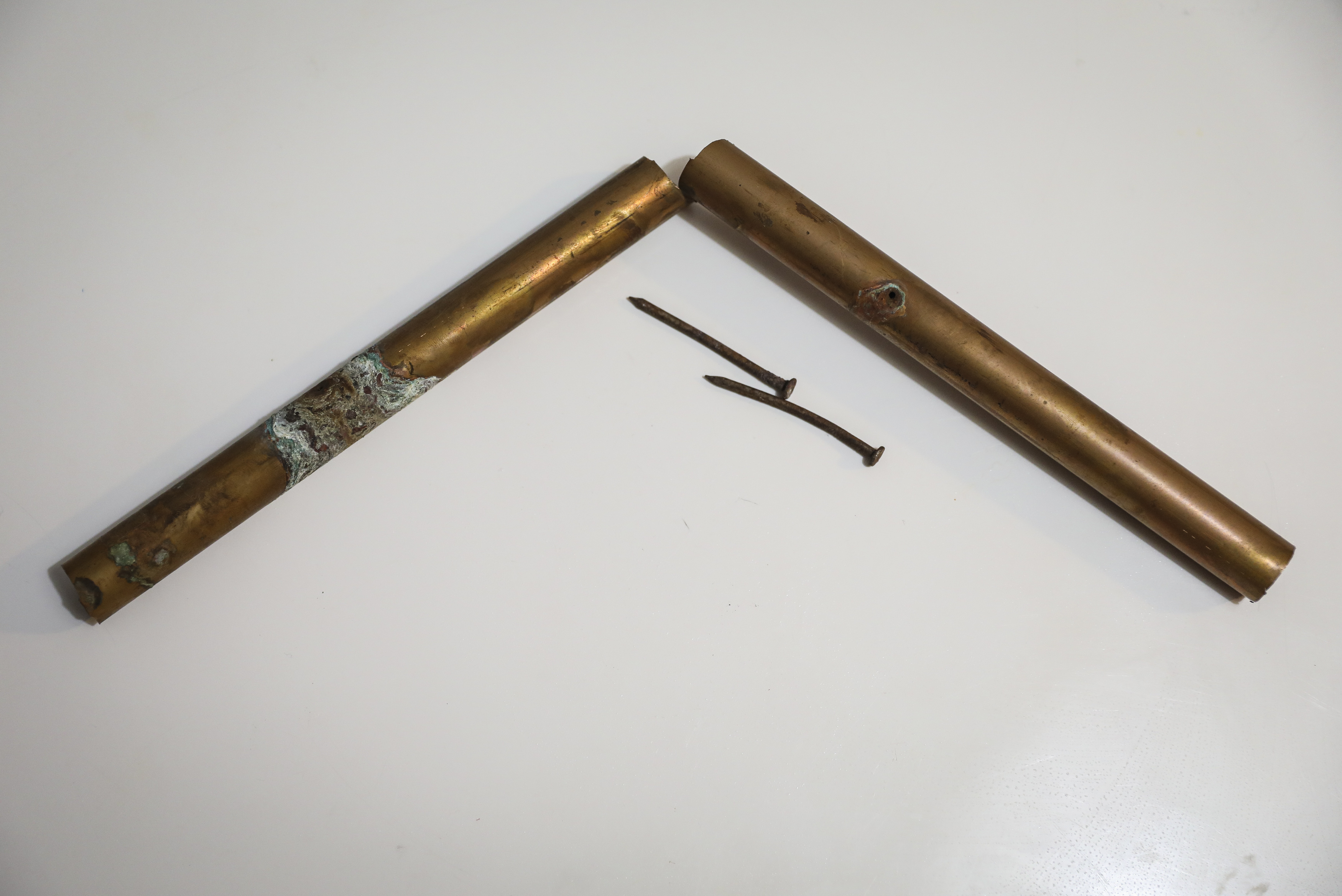 The piece of pipe penetrated by a nail that flooded Nicky Enriquez's apartment.