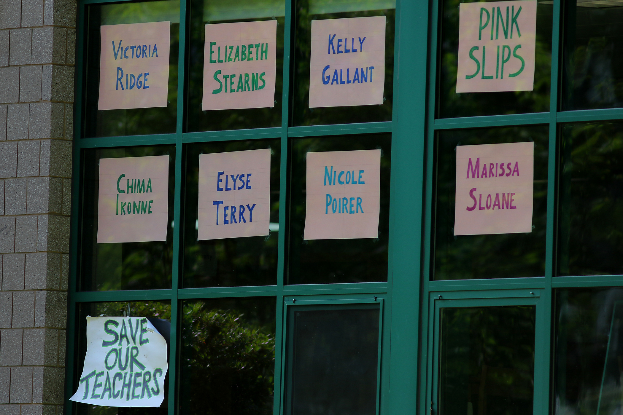 Names of teachers who had received pink slips on the windows of the Heath School.