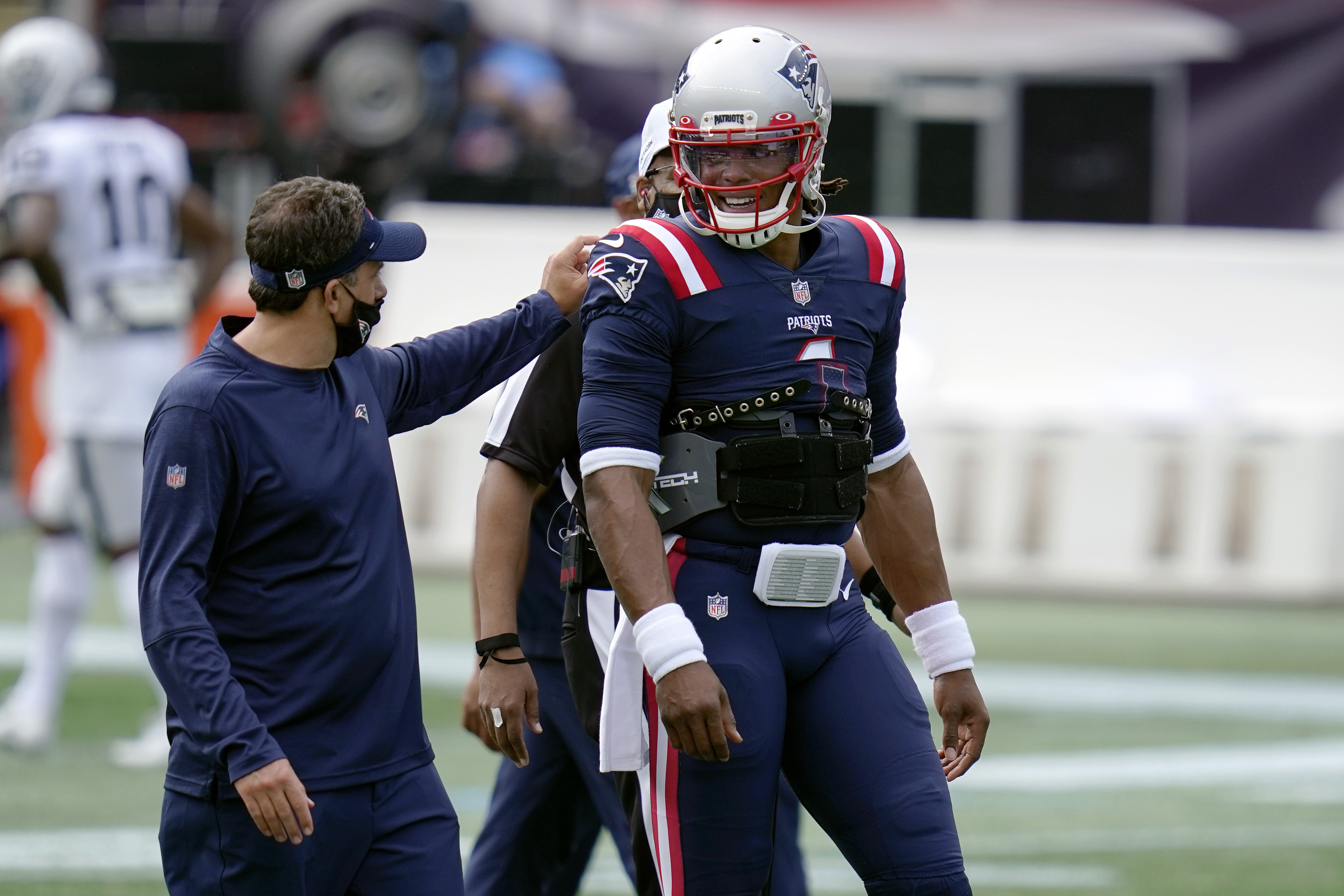 Patriots quarterback coach Jedd Fisch speaks to Cam Newton before last week's game against the Raiders.