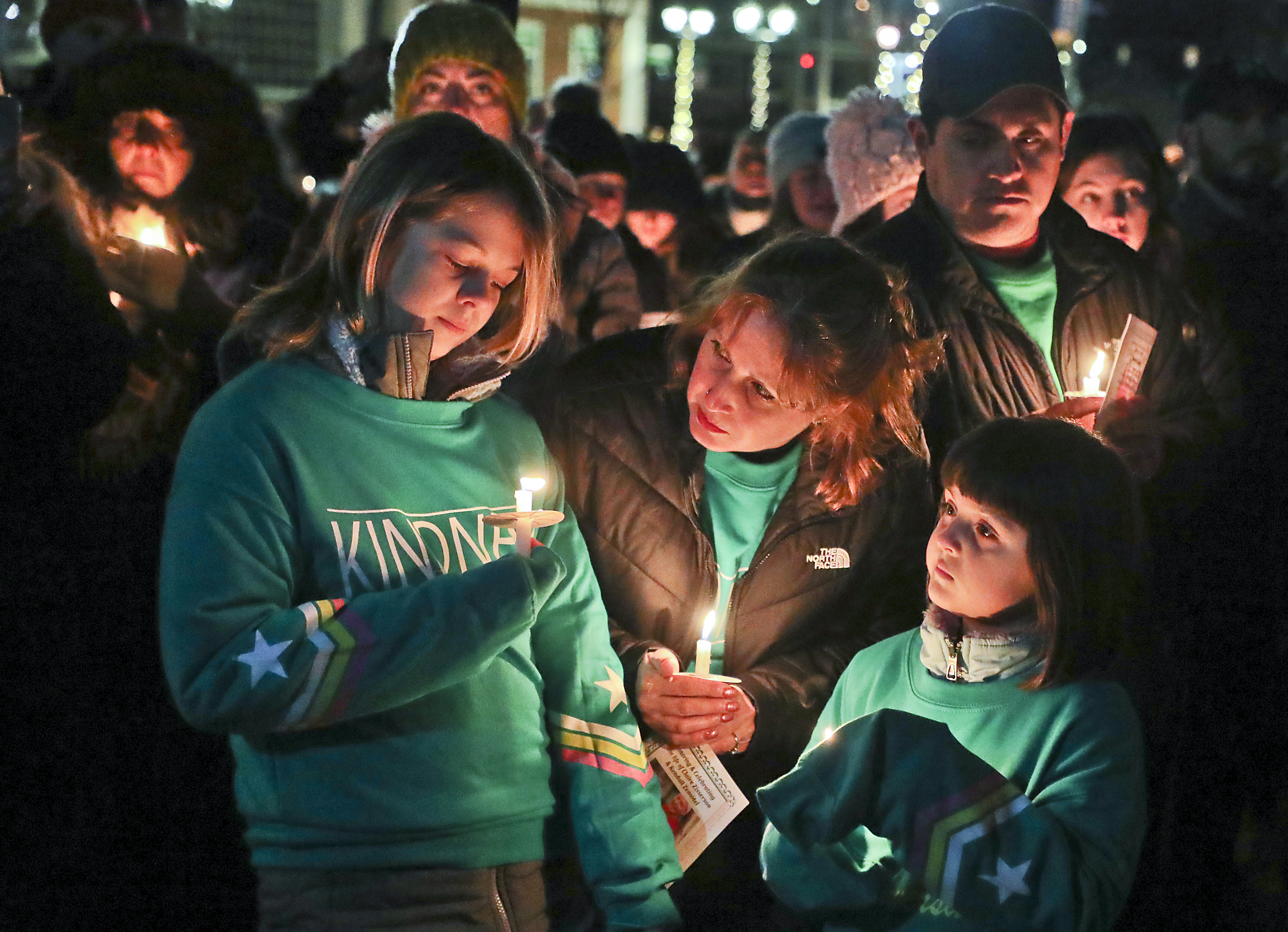 Karin Disciullo stood with her daughters, Kiera (left) and Krystal during a candle light vigil on January 5 honoring the memory of 13-year-old Claire Zisserson, who was killed by an alleged drunk driver in Pembroke.