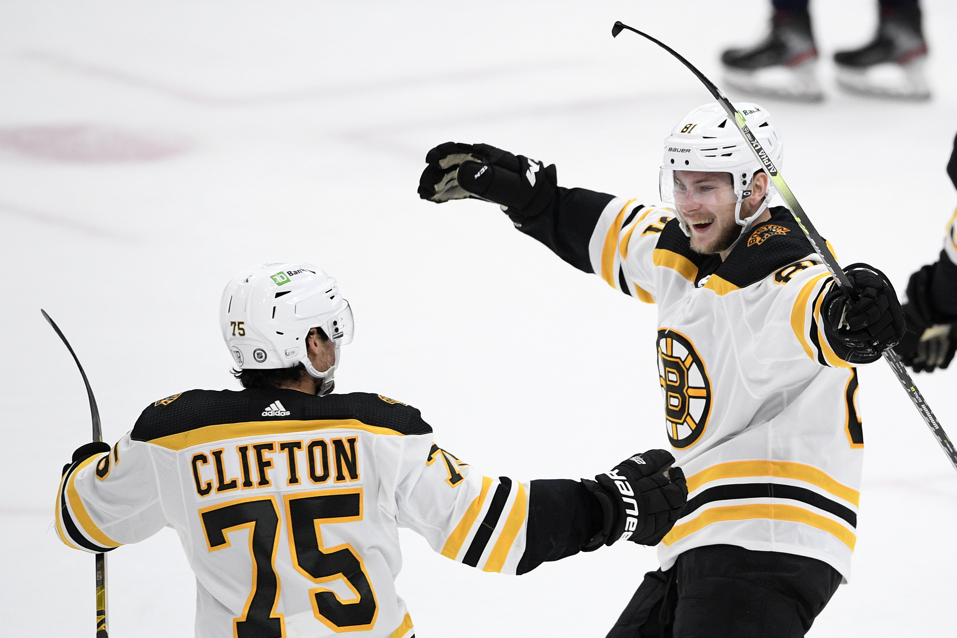 Bruins left wing Anton Blidh (right) celebrates his first goal of the season with defenseman Connor Clifton (75) during the first period of Thursday night's win vs. the Capitals.