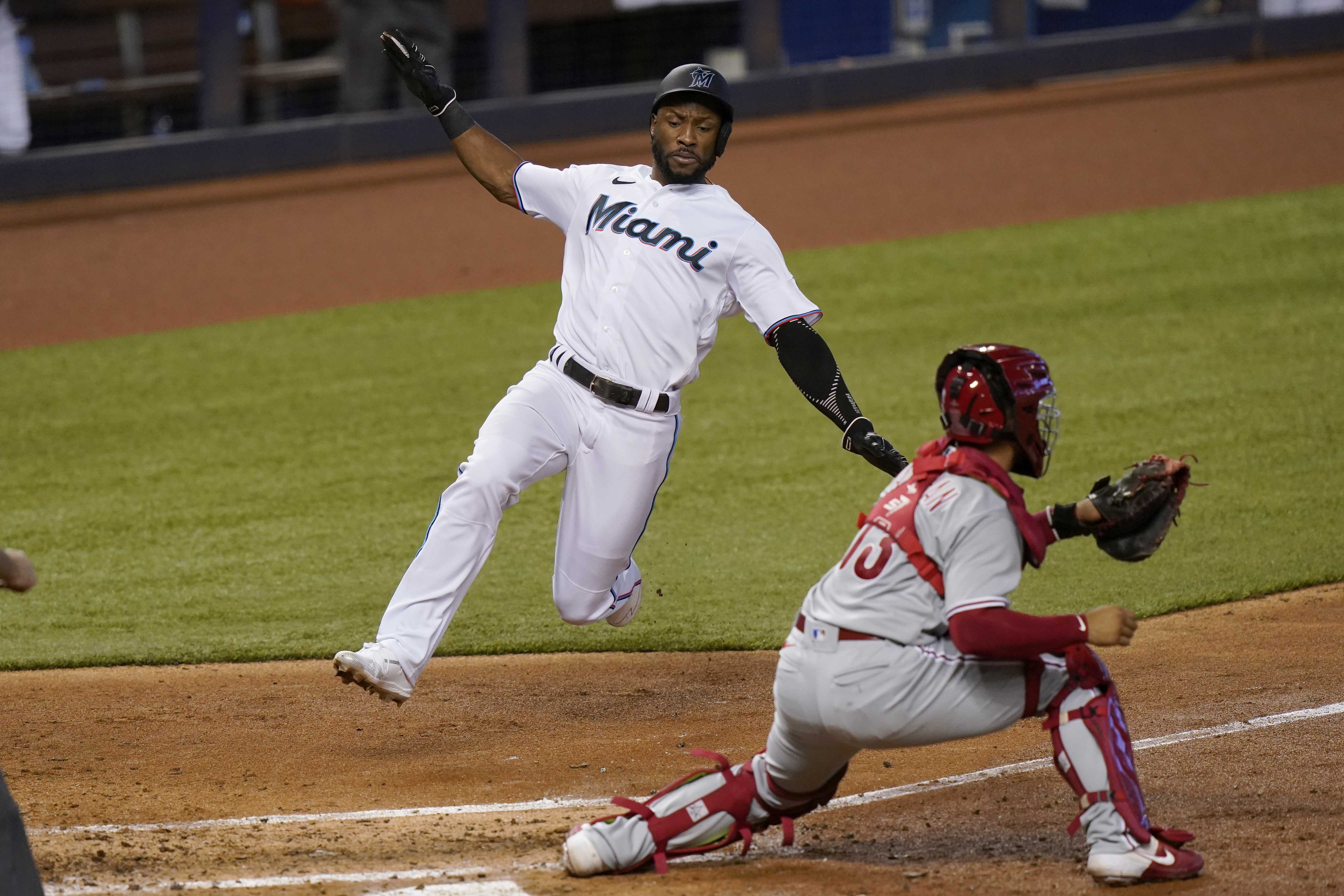 Jean Segura of the Miami Marlins throws his helmet after striking