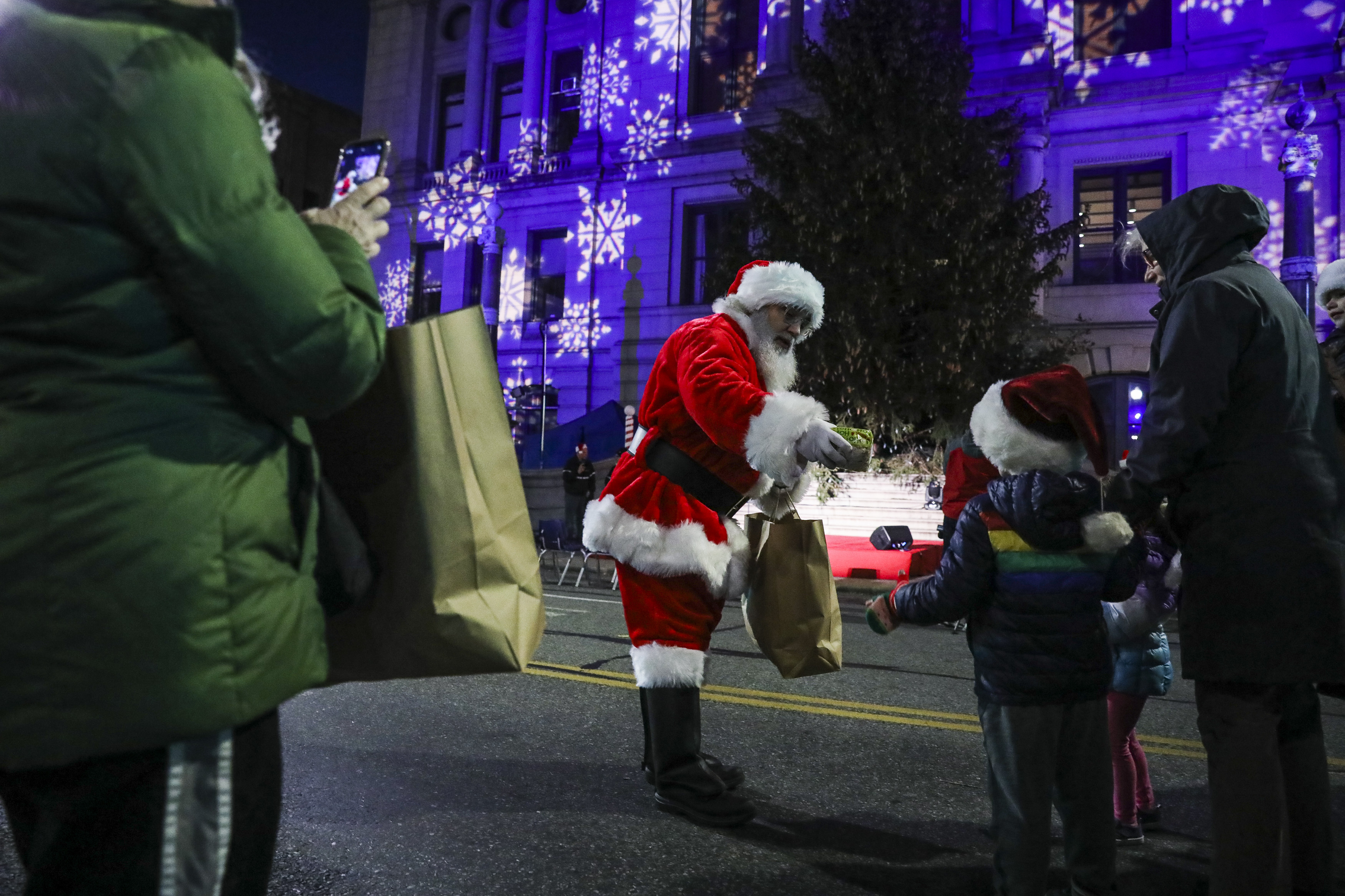 Santa Claus distributes gifts to children.