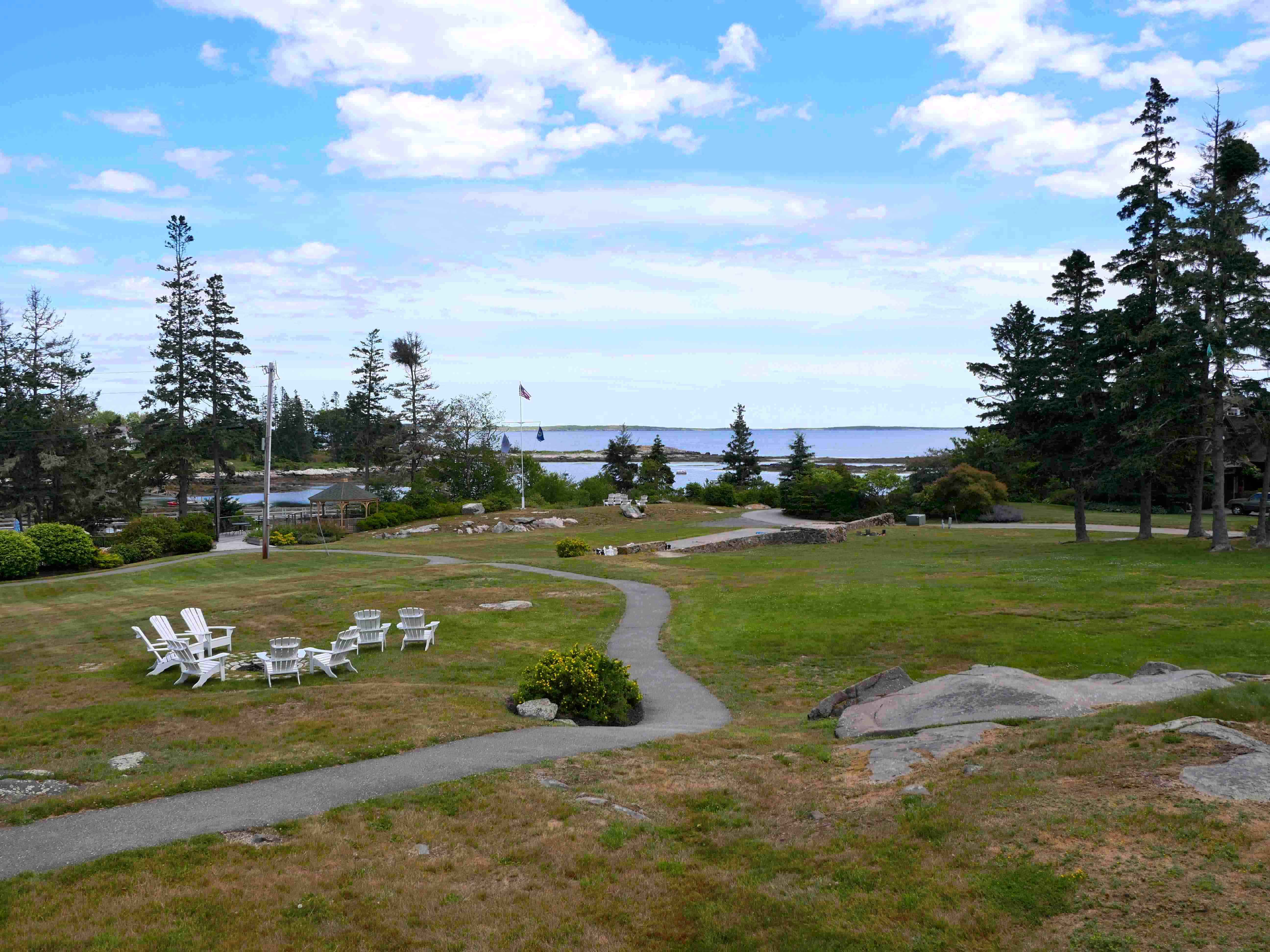 Outdoor tables at the Newagen Seaside Inn's restaurant overlook green lawns rolling down to the ocean.