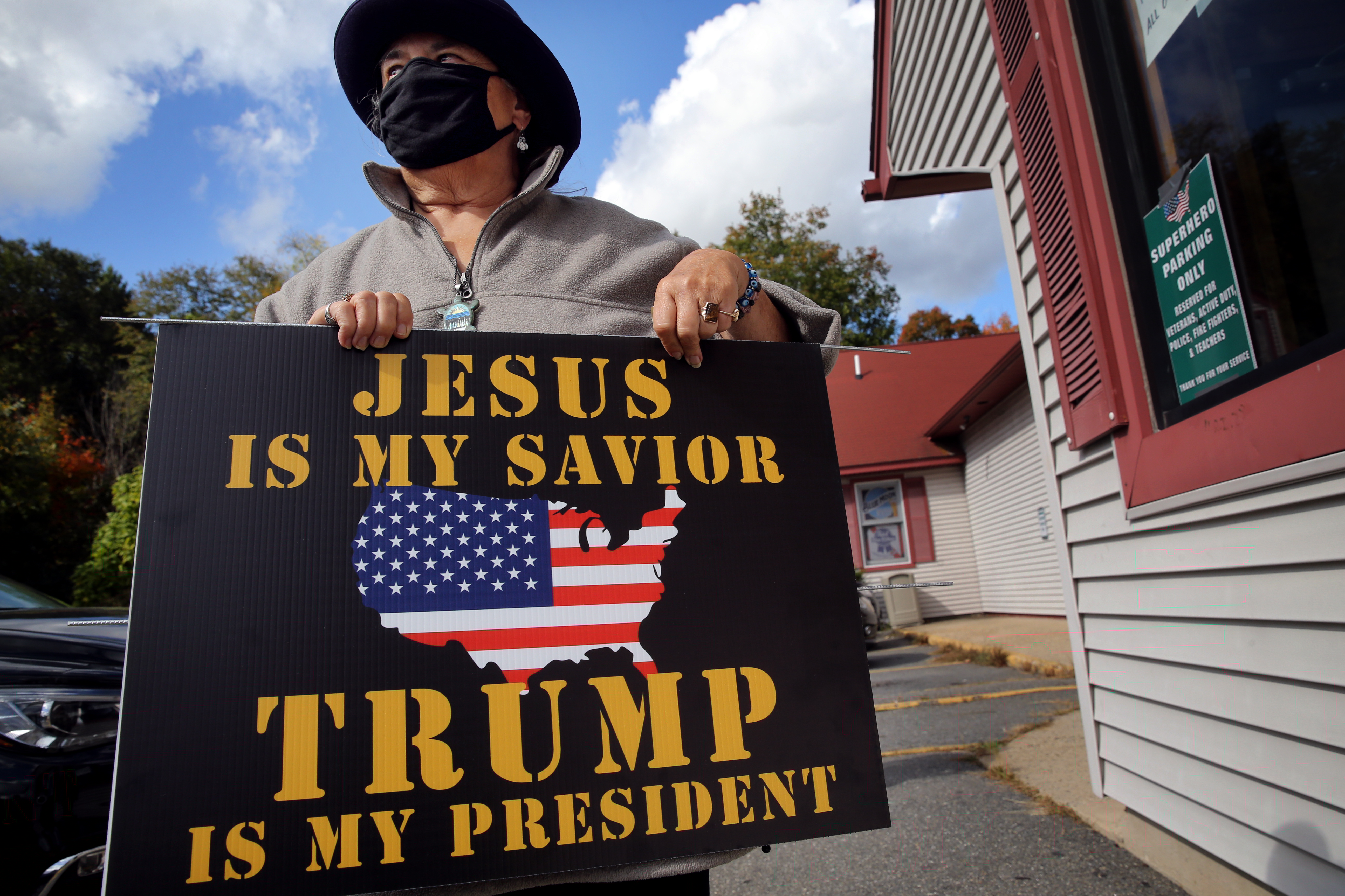 Christine Dube carries a yard sign she bought at The Trump Super Store in Salem, NH on October 03, 2020.
