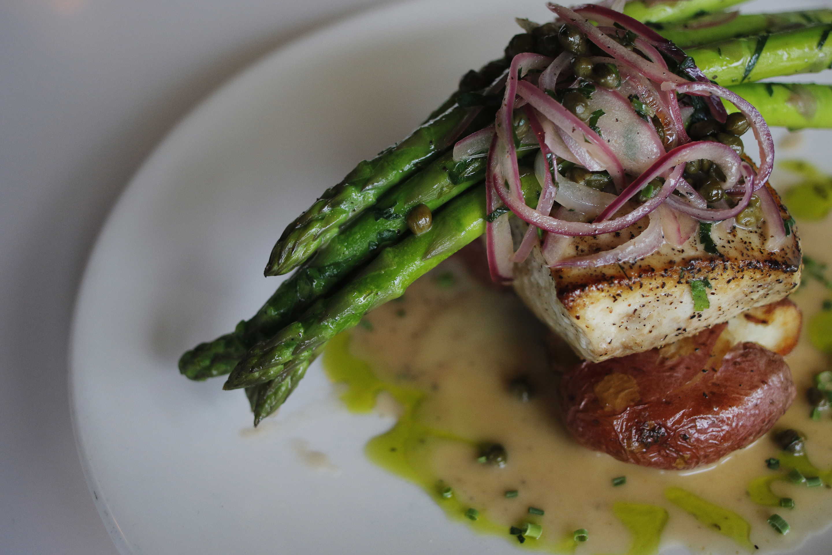 Swordfish "Siciliano" with capers, roasted potato, and asparagus at Stella in the South End.