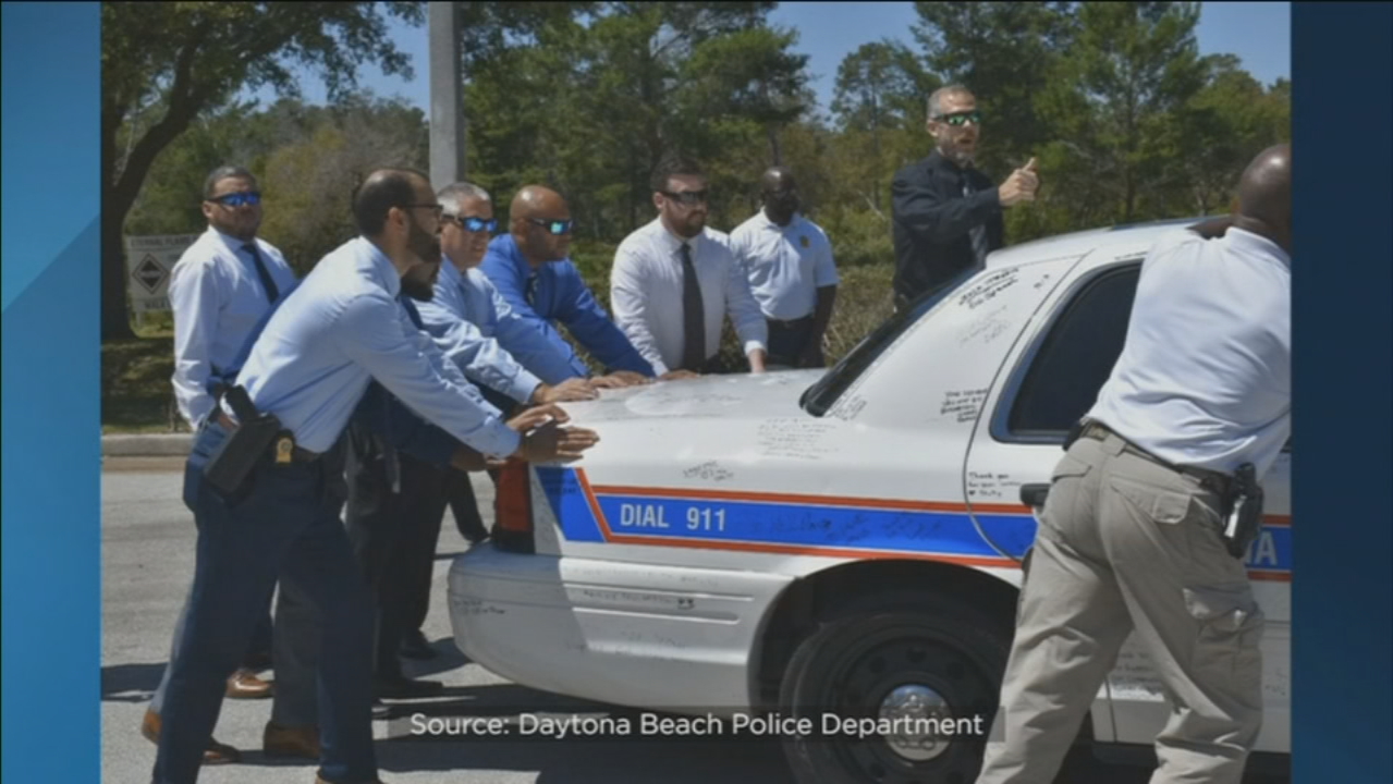 Slain Daytona officer's patrol car signed with messages of honor