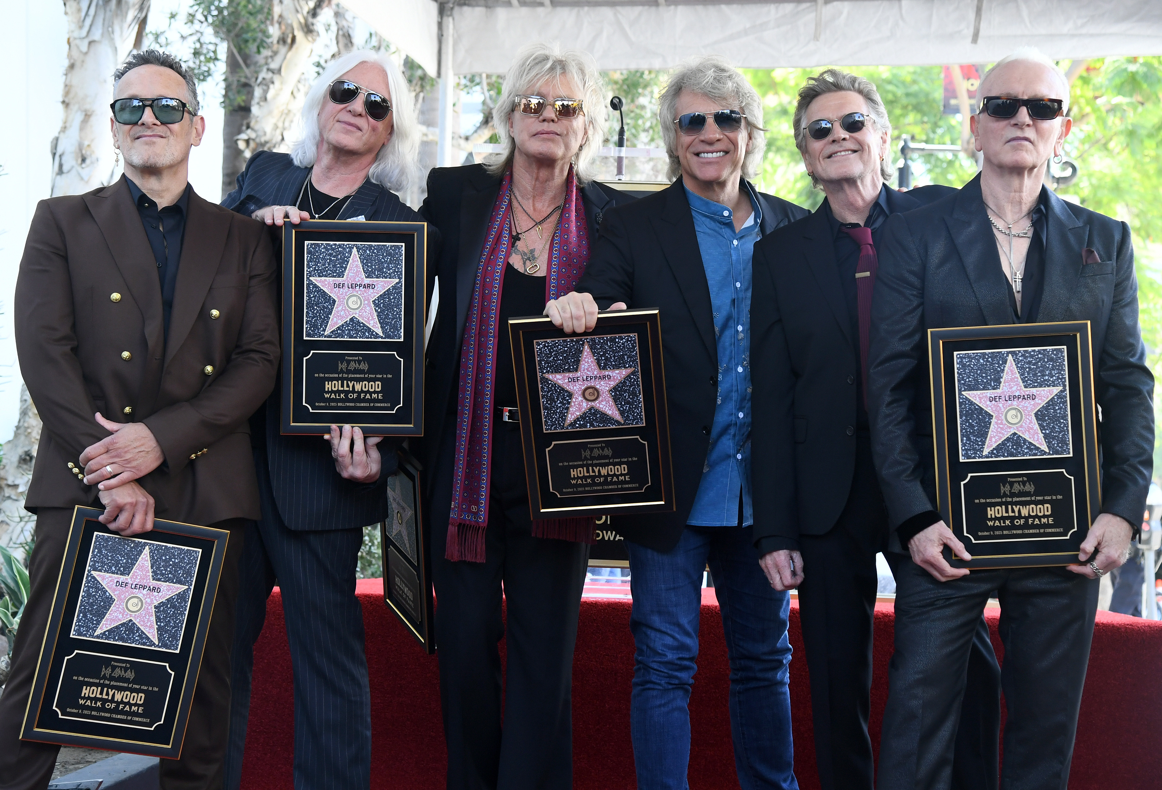 Jon Bon Jovi presents Def Leppard with their star on the Hollywood