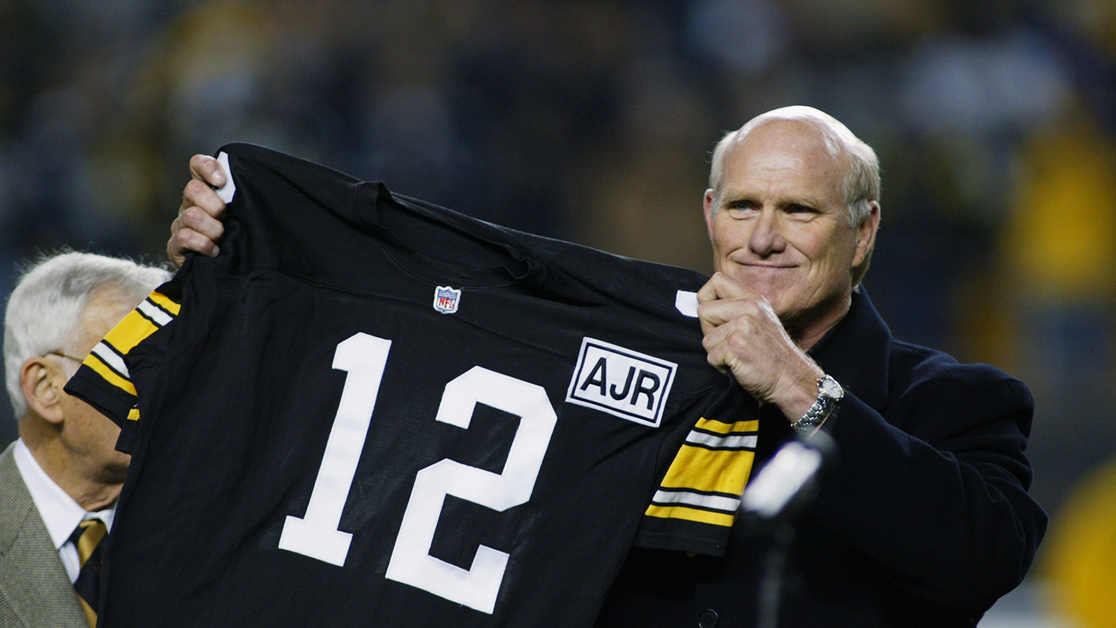 Pittsburgh Steelers quarterback Terry Bradshaw (12) tosses ball to official  signaling touchdown after Bradshaw scored to tie score in AFC Game against  Denver Broncos in Denver on Saturday, Dec. 24, 1977. Denver's