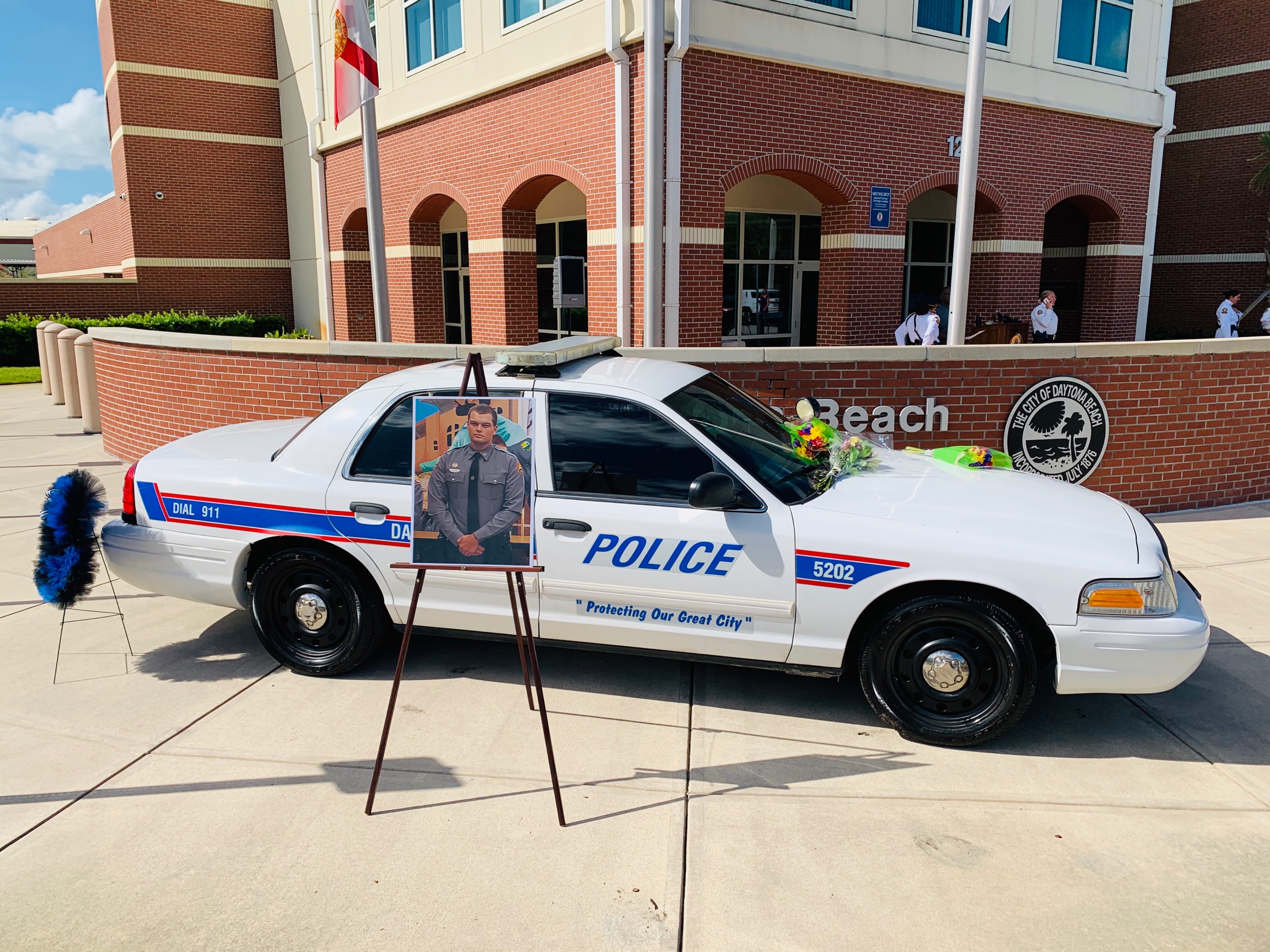 Slain Daytona officer's patrol car signed with messages of honor